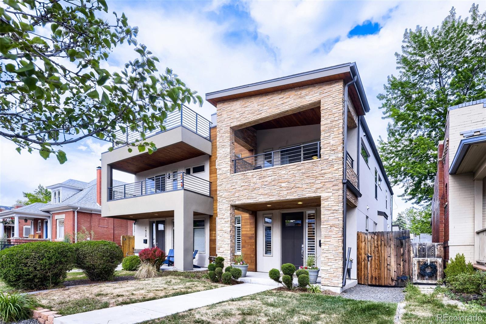 Perfectly positioned in the heart of Platt Park, this beautifully customized duplex blends Mountain Contemporary style with exceptional livability just steps from South Pearl Street’s acclaimed restaurants, shops, farmers market, Whole Foods, light rail, and neighborhood parks. Designed with entertaining in mind, the open main floor features a chef’s kitchen with a large island, Wolf dual-fuel range, expanded pantry, Bosch dishwasher,  knotty alder hardwood floors and doors throughout, and stunning tri-fold glass doors that seamlessly connect the great room to the private backyard and patio. The second floor offers three bedrooms, including a luxurious primary suite with a 5-piece en-suite bath and private balcony overlooking the backyard. A second bedroom was thoughtfully converted into an oversized walk-in closet but can easily be restored as a bedroom or nursery. The third bedroom features a covered deck overlooking vibrant Pearl Street, while a second full bath completes the level. The spacious third-floor bonus room includes a wet bar, half bath, and access to a large deck with amazing views. The finished basement adds a generous family room, fourth bedroom, full bath, and storage room. Additional highlights include surround sound, alarm system, sprinkler/drip systems and 2-car garage with large storage loft. Peaceful inside, yet steps from everything Platt Park offers.