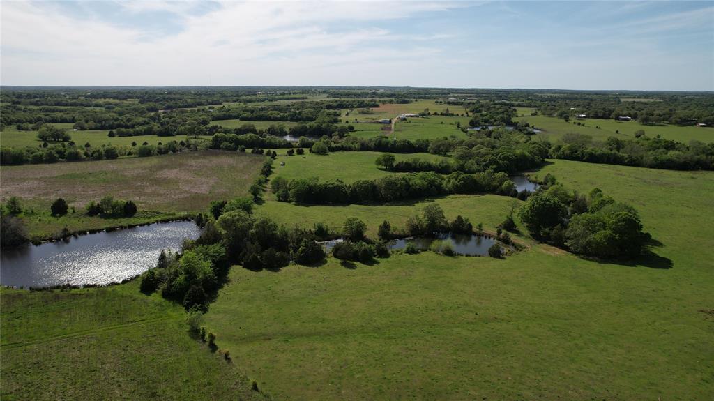 Discover your own piece of Texas paradise with this exceptional 197+ acre ranch, ideally located near Lake Texoma and adjoining Corps of Engineers land for added privacy and breathtaking natural surroundings. This remarkable property features rolling terrain with diverse topography, stunning panoramic views, scattered mature trees, open pastures perfect for grazing cattle, wooded areas for recreation, and multiple stocked tanks filled with catfish and bass—creating the perfect blend of ranching, fishing, and outdoor living.The property currently benefits from an agricultural exemption through hay production, offering valuable tax advantages and added appeal for buyers seeking a true working ranch investment.At the front of the property sits a charming 4-bedroom, 2-bath country home designed for comfort and functionality. Inside, you’ll find a spacious living area, an open eat-in kitchen with a separate dining space, and four generously sized bedrooms, including a private primary suite with ensuite bath. Covered front and back patios provide the perfect setting to relax and take in peaceful Texas sunsets.There is also a second brick home, similar in size, located at the SW Corner of the property.The ranch is also well-equipped for agricultural use with two substantial outbuildings totaling approximately 3,200 and 2,800 square feet, along with ample covered carport space for tractors, trailers, boats, and all your essential farm and ranch equipment.Conveniently located just one hour from the DFW Metroplex and only minutes from shopping, dining, entertainment, and the recreational opportunities of Lake Texoma, this rare offering combines beauty, functionality, and location—making it a true legacy property.
