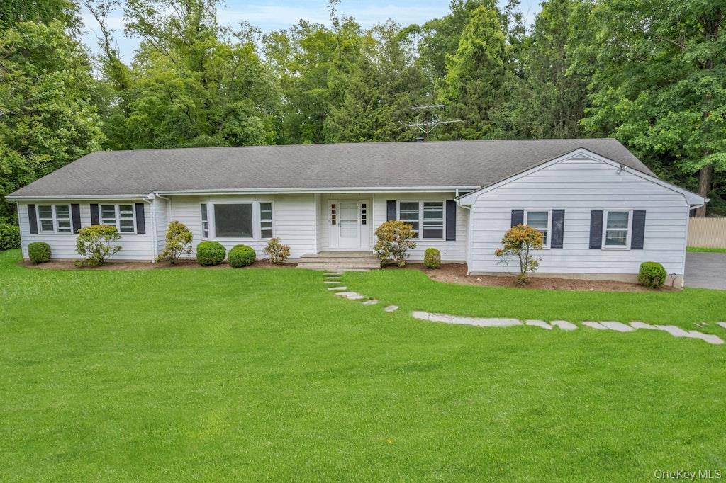 Opportunities like this are measured in acres and location - not finishes. Set on 2 private, level acres on a quiet cul-de-sac street in Armonk, NY. This 4-bedroom ranch delivers single-level living, a classic and comfortable floor plan, and the kind of setting buyers spend years searching for. Hardwood floors run throughout the main level, where the eat-in kitchen opens to a patio, the living and dining rooms connect seamlessly, and the family room features a wood-burning fireplace at its center. The primary bedroom offers an en-suite bath and direct access to the backyard and in-ground pool. A full unfinished basement and 2-car garage round out a footprint that works well today and translates easily into any renovation vision. Central air, natural gas heat, and a whole-house generator are already in place. Byram Hills School District. For the buyer who knows what location and land are worth in Armonk, this is the one.