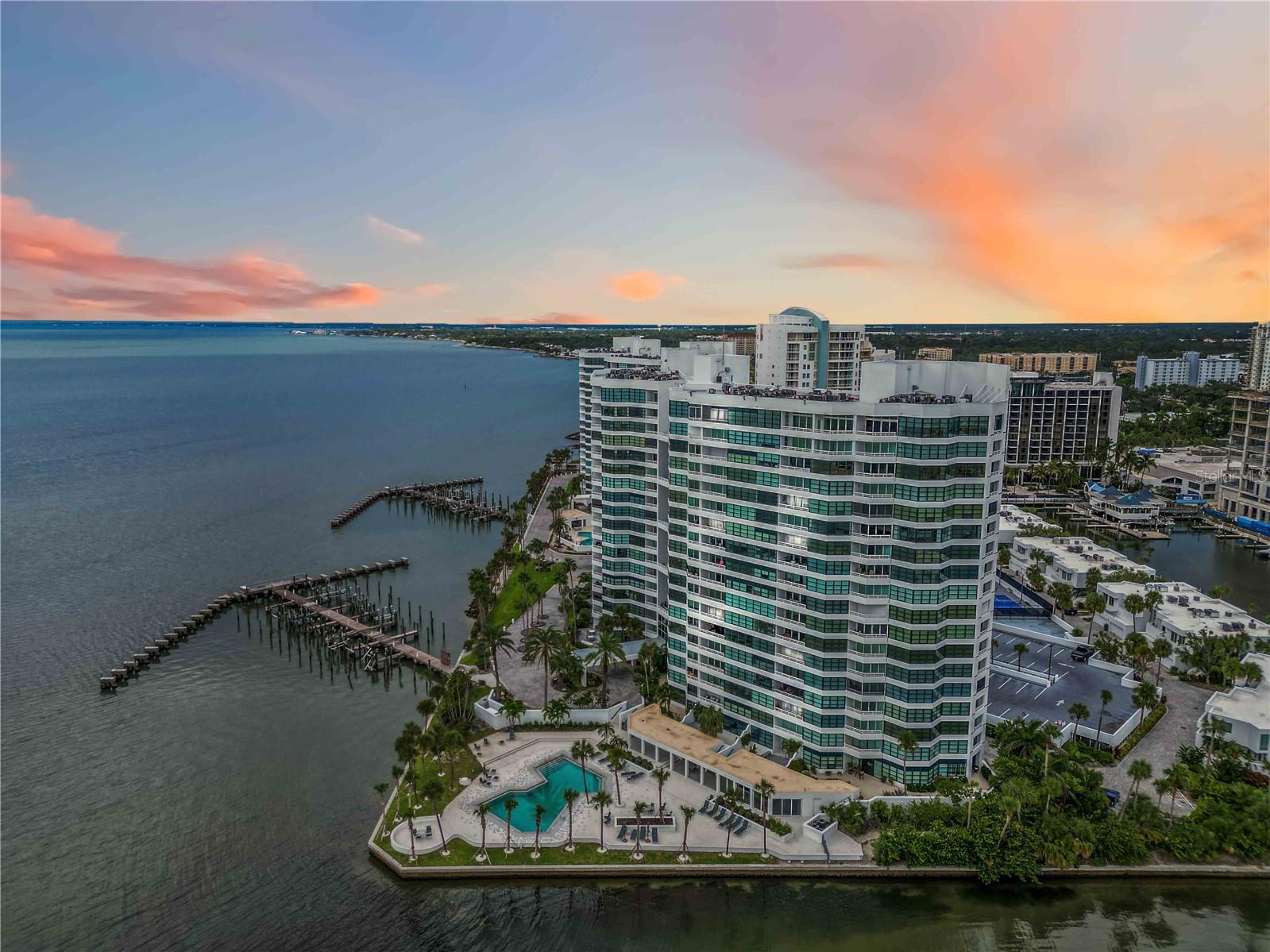 DIRECT BAYFRONT! Rare Opportunity for the buyer that understands value and vision.  Downtown, coveted cultural, waterfront address offering a front row seat of unobstructed views of Sarasota Bay and stunning sunsets.  This direct bayfront residence is located on it’s own private 9 acre peninsula within walking distance to downtown, with an array of restaurants; cultural events; boutiques; whole foods; farmers market and activities.  The new 52 acre Bay Park is directly next door and offers mangrove walking trails; public gardens; children’s play area; yoga; zumba; concert stage; new marina and future new performing arts hall.  Condo on the Bay offers amenities galore:  2 resort-style heated pools, sauna, 2 fitness facilities, social clubroom, library and kitchen; organized activities, sky lobby gathering areas, pickleball; 24hr Security, Concierge services; 24/7 security gatehouse; bike storage; garage & guest parking; EV charging station; fishing pier; kayak, jet ski and boat storage on a first come basis; freshly updated lobbies and on-site management.  The Condo fees include everything except electric.  Panoramic Bay views is what you’ll experience the minute you walk through your front door.  Imagine yourself enjoying tranquil water views from your 7th floor private balcony watching the dolphins and birds play.  This condo provides a blank canvas for a buyer who wants to design a truly custom space tailored to their personal style.   New A/C-2025; Hot water heater-2022; and Sliding Glass door-2023 already in place.  From tranquil sunset strolls along the bayfront to evenings at the opera or ballet, this location put’s Sarasota’s vibrant energy right outside your door.