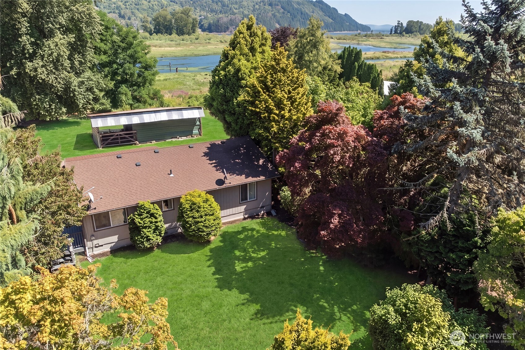 Waterfront, acreage, deep-water moorage, and a peaceful island setting – opportunities like this are hard to find. Tucked along Jackson Inlet off the COLUMBIA RIVER, this Puget Island retreat offers 165' of waterfront, a 90' private dock, and direct access to the water for boating, fishing, kayaking, or simply watching the ever-changing river.    Set on 0.7 acres, the property offers mature fruit trees, a spacious lawn, shaded areas, and room to enjoy the outdoors. The large deck is the perfect place for morning coffee, sunset watching, or simply listening to the water while eagles and other wildlife pass by.    Inside, the comfortable 2-bedroom home offers a spacious, easy-flow layout with both river and garden views. Whether you're searching for a full-time home, weekend escape, or your own private Pacific Northwest retreat, this property offers a lifestyle that's increasingly hard to find. Peaceful and tucked away, yet just 5 minutes to the Oregon ferry, 45 minutes to Astoria, and 90 minutes to PDX.