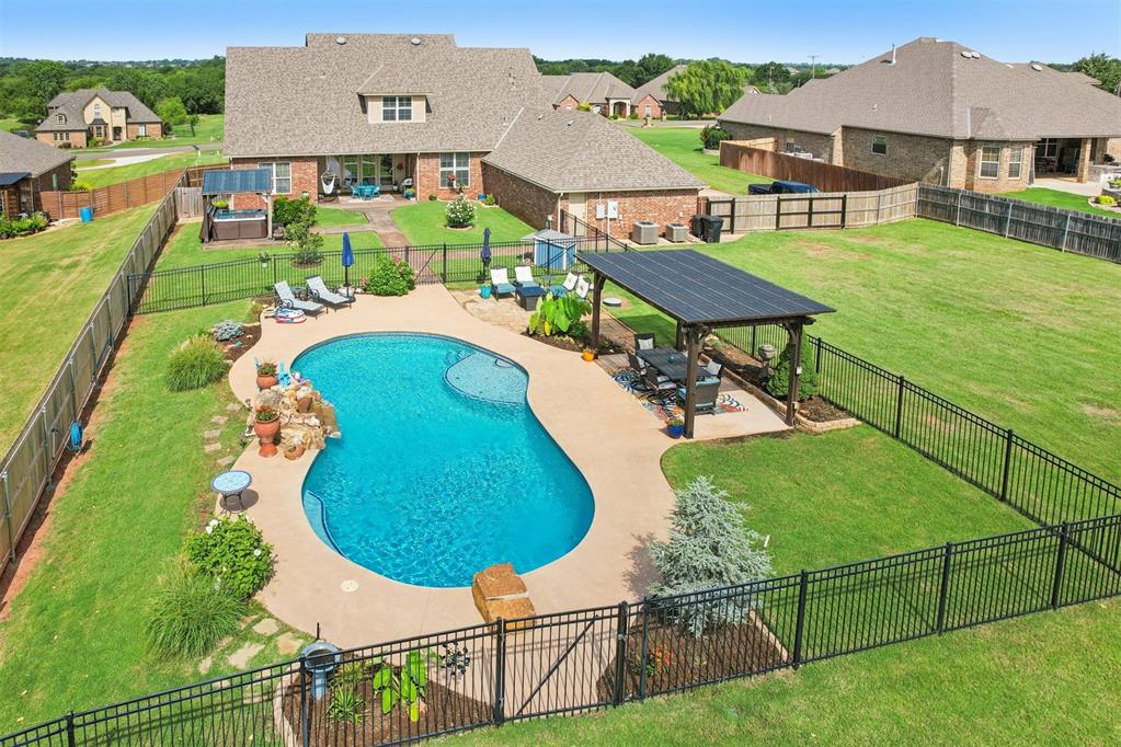 This meticulously maintained 4-bedroom, 3.5-bathroom home offers space, comfort, and style—all nestled on a stunning 1.47-acre lot. From the moment you arrive, you’ll be charmed by the lush landscaping and iconic Weeping Willow tree that sets the tone for this serene property. Step inside to find a spacious layout featuring a large primary suite with a generous bathroom, perfect for unwinding. The upstairs bonus/flex room is an entertainer’s dream—complete with a bar area, a full bathroom, and an additional bedroom, making it ideal for guests, hobbies, or media room use. The backyard is your personal paradise with a gorgeous oasis-style pool, ideal for summer relaxation or lively gatherings. There’s plenty of space to roam, play, or entertain on this expansive lot. You’ll also love the abundance of storage, including multiple walk-in attics and a massive 4-car garage. Recent updates include a new refrigerator and dishwasher inside, plus brand new HVAC systems, an irrigation system, and fencing outside—giving you peace of mind for years to come. This home is truly one-of-a-kind—don’t miss the opportunity to make it yours!