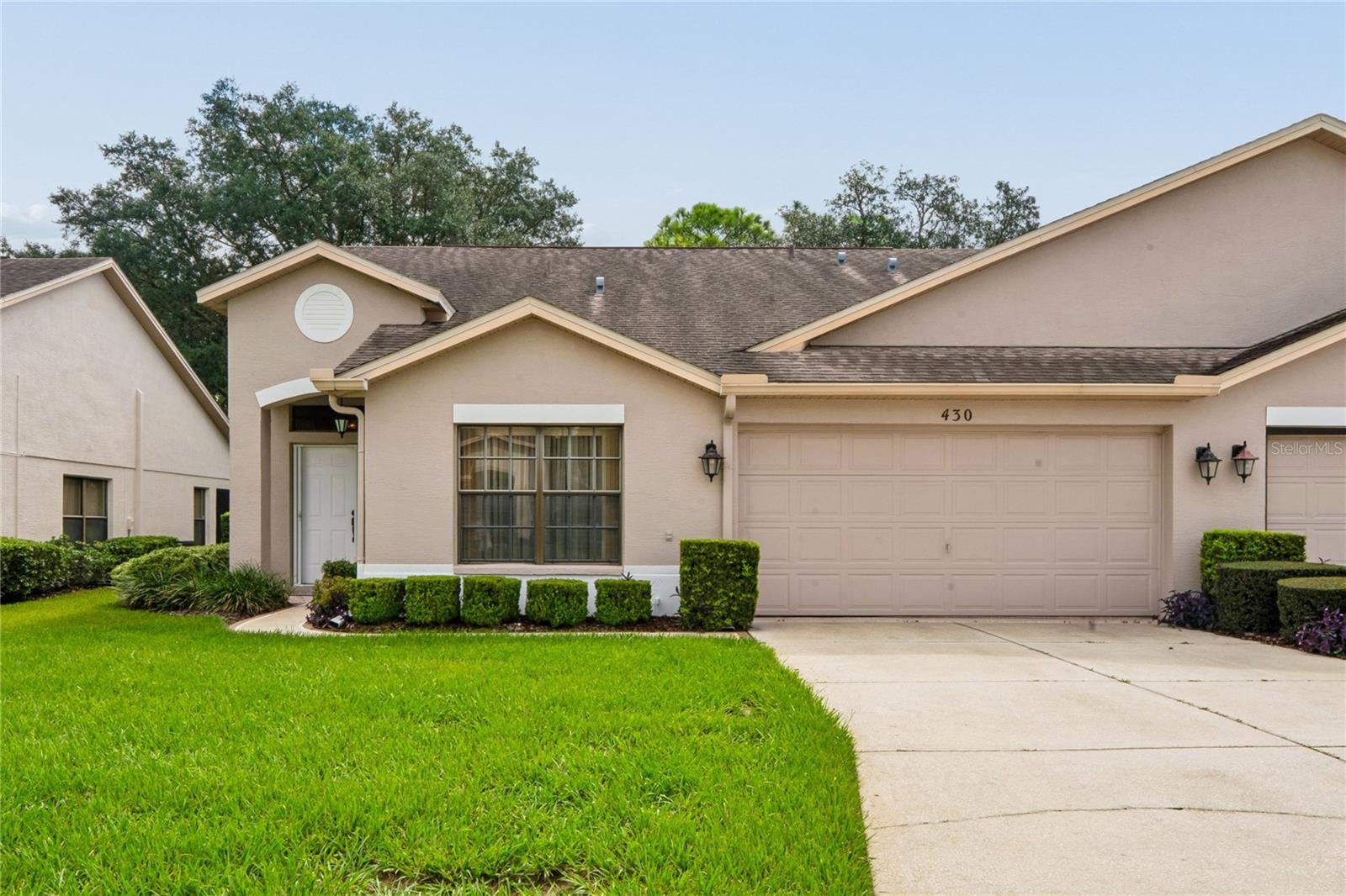Within the desirable Wellington at Seven Hills a 55+ community lies this beautifully maintained two-bedroom, two-bath villa with a two-car garage and comprehensive maintenance package. Ideally located just steps from the clubhouse and pool, this home offers both convenience and lifestyle.Inside, you’ll find soaring ceilings and a spacious layout featuring a formal living room, separate dining room, and an eat-in kitchen with ample cabinetry and a pantry. The owner’s suite includes a private en-suite bathroom with walk-in closet dual sinks, shower grab bars and linen closet, while the generously sized second bedroom can function as a private guest wing or second master suite, complete with a sliding door that separates it from the main living area for added privacy.A glass slider from the family room leads to the enclosed lanai, creating an all-season room with peaceful, park-like views and abundant wildlife—perfect for enjoying your morning coffee while watching the birds. The home also features an inside laundry room with washer and dryer included. Water heater replaced approximately 2025, ac and roof 2015.This home has been well cared for—move right in with nothing to do. Perfect for snowbirds, as furniture is optional.Enjoy dining and socializing at the Wellington Bar & Grill, along with a wide range of amenities included in the monthly HOA: fiber optic internet and TV, a resort-style clubhouse, pool and spa, pickleball and tennis courts, bocce, billiards, fitness center, and a full calendar of clubs, trips, and activities. Be as active as you’d like!Maintenance-free living includes lawn care, exterior painting (every 10 years), sprinkler maintenance, roof replacement (approx every 20 years), and more (see attached HOA maintenance document for full details).Located just 45 minutes from Tampa and close to beaches, kayaking, and fishing, this home offers the perfect balance of relaxation, recreation, and convenience.