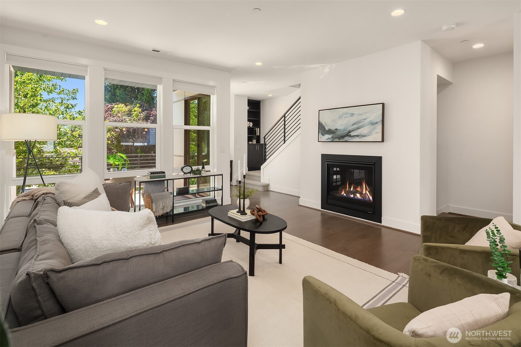 Welcome home to Dawson Square—where timeless design meets modern convenience in the heart of Downtown Bothell. This beautifully crafted, sun-filled, south-facing townhome features soaring ceilings, hardwood floors, and an open-concept main floor with a spacious kitchen, dining area, cozy gas fireplace, and private deck. Upstairs, the vaulted primary suite offers a spa-inspired oversized shower and generous walk-in closet, with two additional bedrooms and a full bath nearby. A lower-level guest suite with its own ensuite bath is ideal for visitors or a quiet home office. Enjoy upgraded finishes, a two-car garage, and thoughtful details throughout—just moments from parks, shops, dining, and trails in the top-rated Northshore School District.