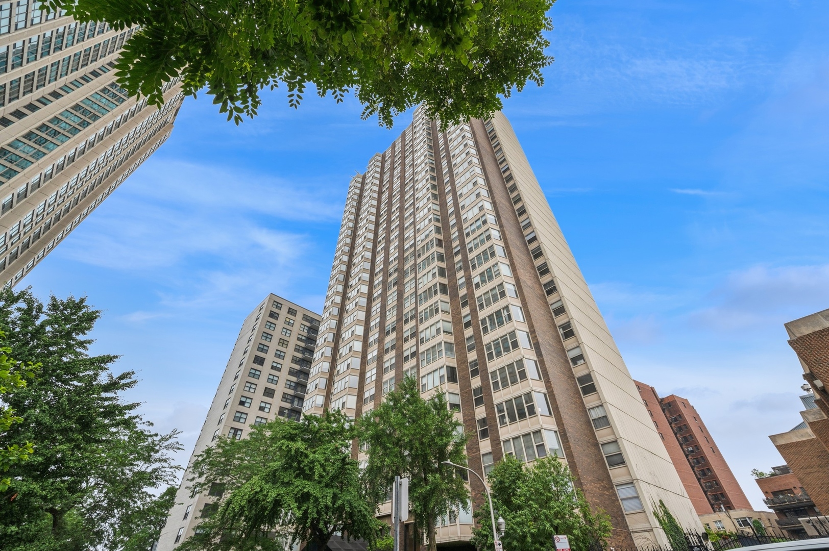 Beautifully maintained and completely turnkey, this split 2BD/1BA home in a full-amenity building offers comfort, style, and convenience. Enjoy newly refinished hardwood floors, fresh carpet, and a bright white kitchen and bath with stainless steel appliances. Thoughtful updates throughout make this home move-in ready. Large windows offer serene views of treetops, the harbor, and Lake Michigan as you look east down charming Hawthorne Place. Just steps from the lakefront and minutes to Wrigleyville, Andersonville, Southport, and downtown. Building amenities include a fitness center, outdoor pool, and an expansive 2nd-floor deck with pergolas and seating-perfect for relaxing or entertaining.  You are conveniently within steps of the 151 bus to downtown.
