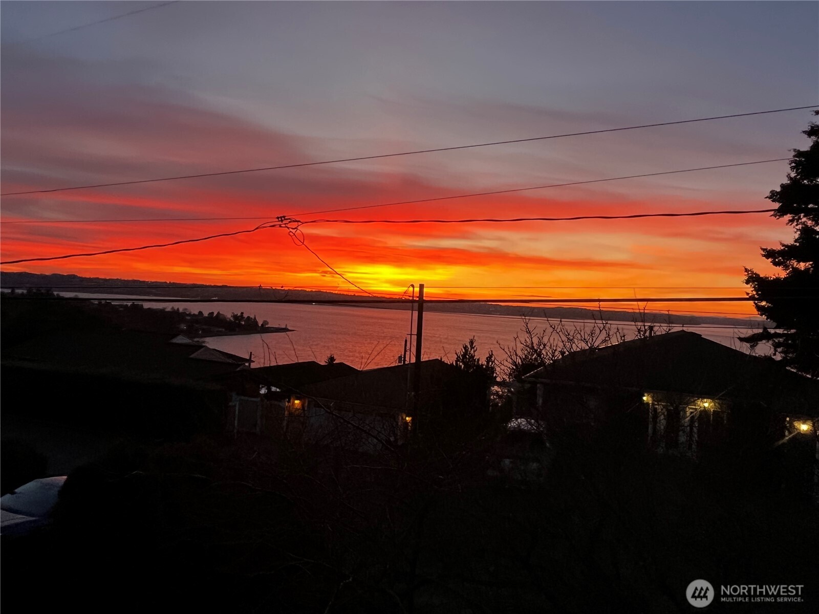 Enjoy endless views of passing ships on the sound, city lights & beautiful sunsets. Handicap access w/Elevator, extra wide doors & halls. Low maintance w/metal roof, metal siding, great wood stove & passive solar floors heated by the Sun. Spacious open concept w/vaulted ceilings, skylights & big view windows. Beautiful white oak floors w/Fir trim. Large kitchen w/custom cabinets, granite, 2 ovens & new refrigerator. Modern wiring w/double coax for cable & Cat 5E wiring for fast internet, DSC security system & security camera wiring. Bonus room wired for projection TV & plumbed for wet bar; options are endless for this room. Cold rm for wine cellar. Large garage fits full size truck has 220 outlets for charging car. Cherry, Peach & Plum trees. Sought after neighborhood. Room for RV parking for boats or toys. Set up your appointment to walk thru today. Elevators are required to have communication so buyers need to know all wall phones stay w/the home & must be operational for emergencies Lightcurve in Tacoma have them set up on the net w/ your internet it runs about $62.00 a month for all. Some virtual staging. No HOA Unincorporated Pierce County=better taxes. You may cut your trees 4 even better view.