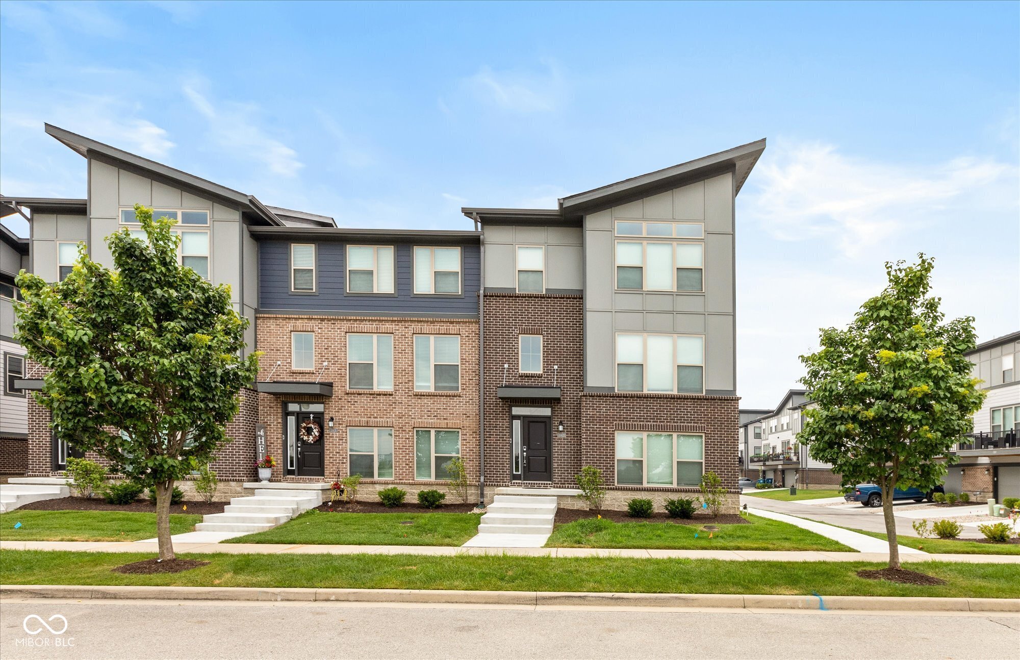 Welcome home to a three-story haven of contemporary design and functional elegance. This nearly-new townhome is the perfect blend of style, space, and convenience. Just a year old, it offers a flexible lower level you can use however you like-home office, workout space, or a cozy media room. Upstairs, the main level has an open, airy feel with a big kitchen island, a gas range, and plenty of room for casual meals.  The upper level has three bedrooms, including a spacious primary suite with a large tiled shower and a walk-in closet. You'll also love the convenience of the upper-level laundry room, complete with a washer and dryer. Step out onto the balcony and savor the fresh air. This home is truly move-in ready-no waiting to build or dealing with the extra costs of window treatments and appliances. Plus, you're just a short walk away from local restaurants, a gym, a neighborhood park, and highly rated schools.