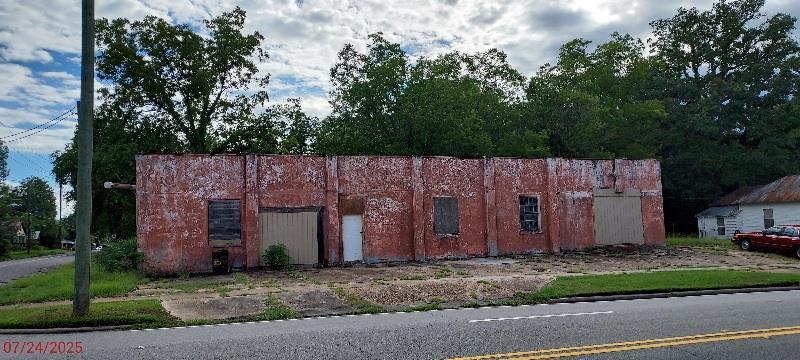 Subject property has approximately 2500 sq. ft with a corner location. The extra lot in back (52x105) goes with the sale and is zoned m.