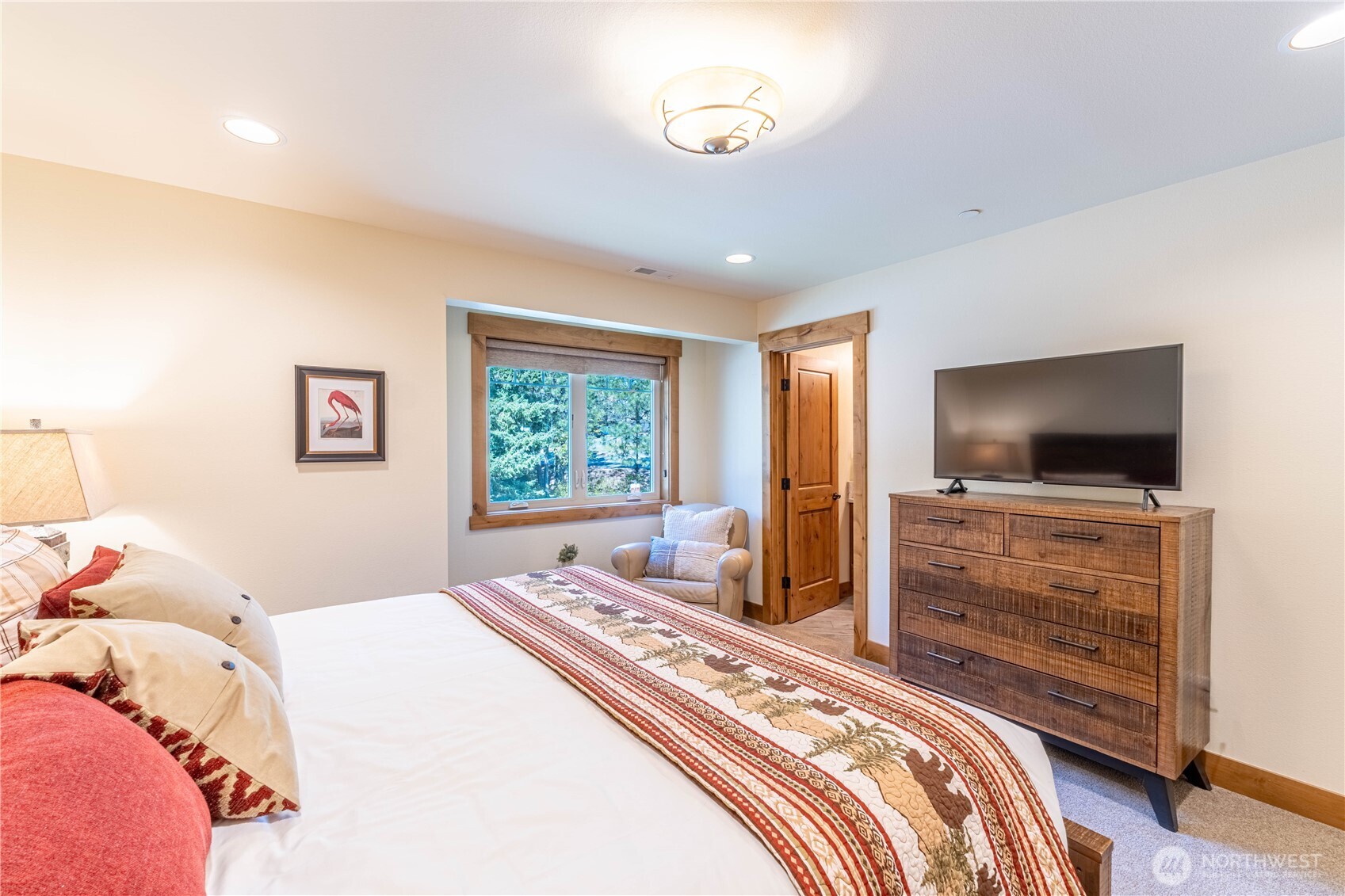 Spacious second king bedroom with a comfortable sitting area, ideal for unwinding.