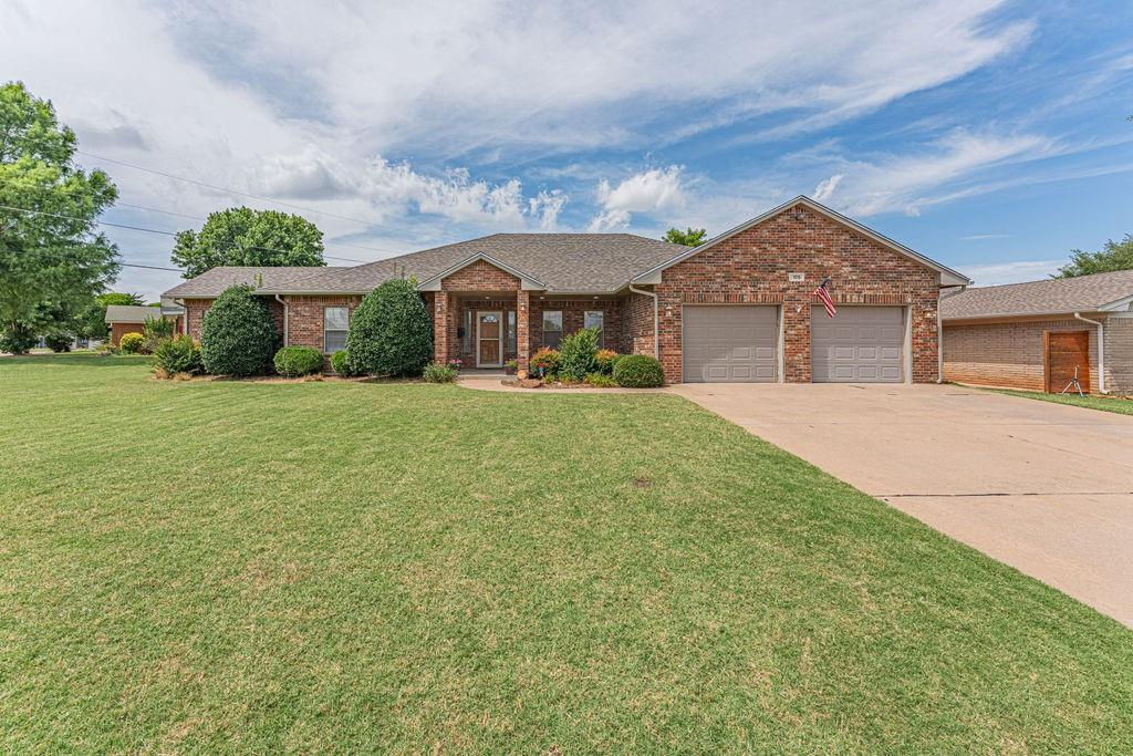 Stunning custom built 3 bed 2.5 bath home built in 2003 in an established neighborhood with no HOA!! Eat in Kitchen with a separate dining room and a pantry. Fireplace in the living room provides a cozy home feeling with the wood floors! Doors in Living Room provide access to the back porch that is covered and perfect for entertaining. Separate door in the eat in kitchen area provides a second outdoor access.  Home comes with a gas grill that has its own gas hook up on the back porch. Large master en suite bathroom with jetted soaking tub and large walk in closet. Large laundry room provides area for folding and storage.  Beautifully landscaped lot in front and back yard. New roof was installed in April 2025. Garage features an in ground storm shelter. All of this on a corner lot!! Buyer to verify all info.