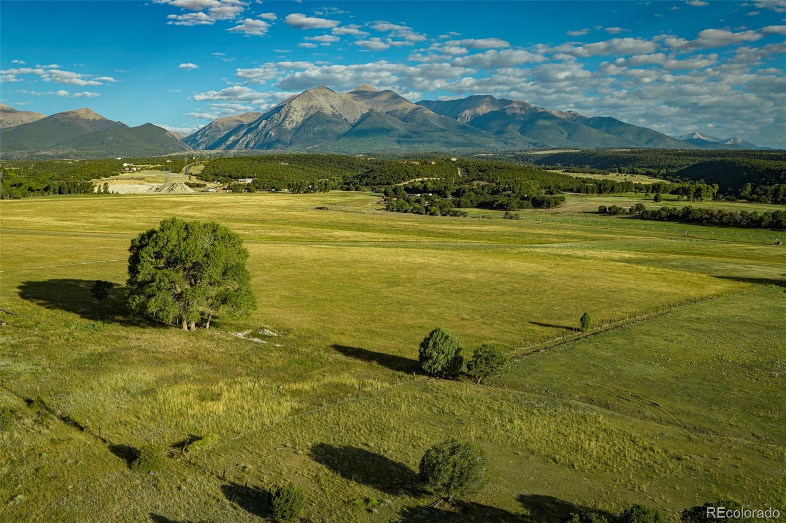 192 acre Salida, Colorado ranch for sale.  Senior water rights irrigate approximately 100 acres of the ranch.  Three shares of the North Fork Ditch flow into a reservoir on the ranch and are gravity fed through a buried pipeline to a center pivot and gated pipe producing up to 245 tons of grass hay annually.   Historic 3 bedroom, 2 bath home has been renovated over the years but retains its heritage and old farmhouse feel.  There are multiple building sites on the ranch to construct homes/structures if desired.  Multiple outbuildings including a cellar/meat processing room, a shop, older barn and a few other smaller structures.  A secluded valley on the ranch features a rustic private campground with cook shack, covered gazebo, horseshoe pits, gravity water system, and wiring for lights and outlets to be run by generator.  Large resident elk herd frequents the ranch in the fall and winter and the ranch currently receives 5 cow elk vouchers and is eligible for the land owner preference drawing for deer and elk.  No conservation easement, no covenants or HOA.  This is a rare large acreage opportunity in the Salida area with senior water rights within 15 minutes of downtown.