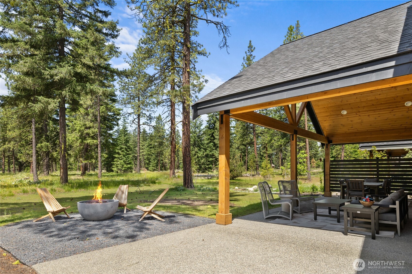 Expansive covered back patio adjacent to protected 3-acre meadow.