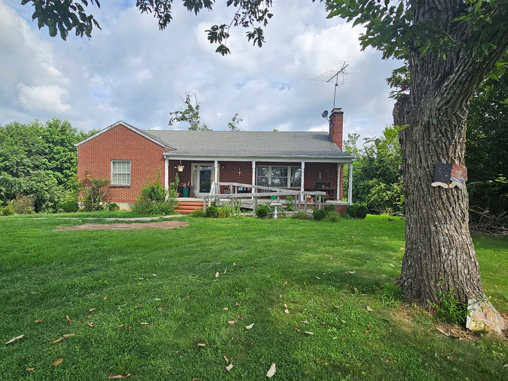 Charming brick ranch home with basement situated on 1.85 peaceful acres in the countryside. This 2-bedroom, 1-bath property offers great potential with some needed updates, and is priced to sell. Features include beautiful hardwood flooring, a spacious living room with a cozy fireplace, a separate den, and both a heat pump and oil furnace for year-round comfort. Enjoy the outdoors from the covered front porch, and take advantage of the paved driveway for easy access. Conveniently located just minutes from the Blue Ridge Parkway, Fancy Gap, VA, and Mt. Airy, NC—this is a good opportunity to enjoy country living with nearby amenities and scenic views. Call Today!