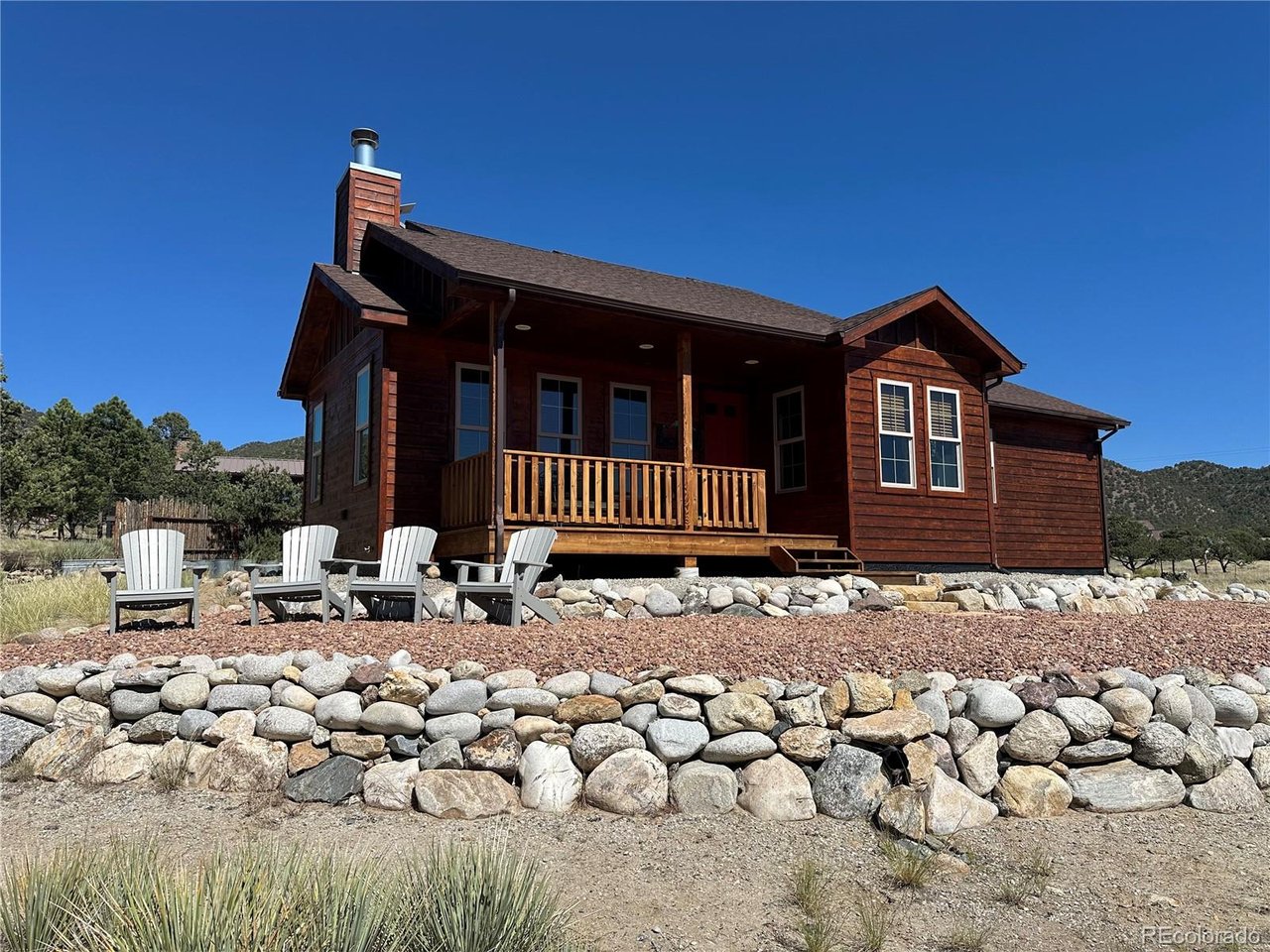 New photos posting 6/22, showings start 6/21! Looking for a home close to town that isn't in a HOA? This home built in 2011 sits just 3.5 miles from downtown Salida, placing you minutes from groceries, galleries, and restaurants! The quality of this home will exceed your expectations. Vaulted ceilings, 8' solid wood doors, engineered hardwood floors, and textured walls throughout. The living room is classic Colorado with a wood ceiling, gorgeous fireplace along the north wall (wood burning with a gas connection), and west-facing windows that allow you to take in the gorgeous sunsets along the Continental Divide. With an open floor plan, the chef will love to prepare meals and still be part of the conversation. The kitchen is equipped with stainless steel appliances, including a coveted convection oven. The dining area will soon become your favorite spot, with windows on three sides - you will be surrounded by nature. When you are ready to rest, relax in the primary suite. It features a walk-in closet, en suite bathroom with dual copper sinks, private water closet, and tub/shower combo. Wake up to breath taking views over the valley looking directly at the mountains through the tall west-facing windows.  The second bedroom is currently being utilized as a home office with the second bathroom located just outside of it.  That bathroom features a glass enclosed tile walk-in shower and granite topped vanity.  At the end of the day, sit back and overlook the valley from the covered front porch, listening to the variety of birds that love to nest in the numerous pinon pine trees on the property.  Pinon Hills features paved county-maintained roads, large lots, and friendly neighbors. The exterior was professionally sanded and stained in the Spring of 2026 at a cost of $23,000 then new exterior lighting was installed.  Walking up to it, it now looks brand new!  Seller added an exterior heated studio/office in 2025, along with a Tuff Shed for storage.