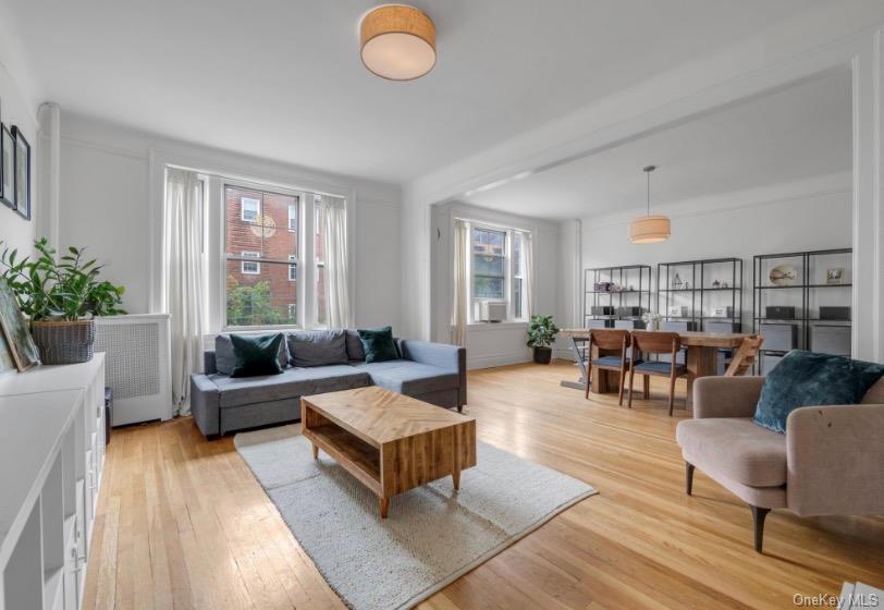Welcome to Landmark Hampton Court, a distinguished prewar condominium/cooperative residence in the heart of the Jackson Heights Historic District. Built in 1920 and designed by architect George H. Wells. Offering an intimate living experience, the building features just three units per floor with a total of 15 residences. This bright and inviting two-bedroom, one-bath home offers classic architectural character with a highly functional layout. Situated on the fourth floor, the apartment features oversized east- and west-facing windows that provide excellent natural light throughout the day. Interior details include approximately nine-foot ceilings, plaster walls, oak strip flooring, and elegant moldings, all contributing to the warmth and charm of a traditional prewar home. The residence includes a welcoming foyer, double sized living room with potential opportunity to utilize into guest bedroom and/or study room, two well-proportioned bedrooms, and updated kitchen and bathroom spaces.Hampton Court is widely admired for its beautifully maintained interior garden, considered one of the most appealing courtyard spaces in the Historic District. The building is well cared for and offers practical conveniences, including basement laundry facilities, a complimentary storage bin, and the services of a live-in superintendent.The location offers an exceptional combination of neighborhood character, daily convenience, and transportation access. Travers Park is approximately 0.3 miles away and provides tennis courts, basketball courts, playgrounds, and open recreational space. The residence is also close to the 34th Avenue Open Street, known as Paseo Park, a multi-block pedestrian and cycling corridor that enhances the area’s residential appeal. The 37th Avenue retail corridor is approximately 0.15 miles away and features a variety of coffee shops, restaurants, and neighborhood grocers, including Ferreira Foodtown, Food Dynasty, and Premium Market. Subway service at 74th St–Broadway and Jackson Hts–Roosevelt Ave—serving the E, F, M, R, and 7 trains, along with the LaGuardia shuttle—is approximately 0.4 miles away, providing convenient access to Manhattan and the surrounding boroughs.Interior Features• Expansive living room suitable for everyday living and entertaining• Oversized east- and west-facing windows with generous natural light• Approximately nine-foot ceilings that enhance the sense of space• Excellent cross-ventilation with windows on both sides of the residence• Oak strip hardwood flooring that complements the prewar design• Newly installed dishwasher and stove for added kitchen convenienceOutdoor and Building Conveniences• Beautiful shared courtyard garden offering a peaceful outdoor setting• Low monthly maintenance fee• Basement laundry facilities and additional storage space for added convenience
