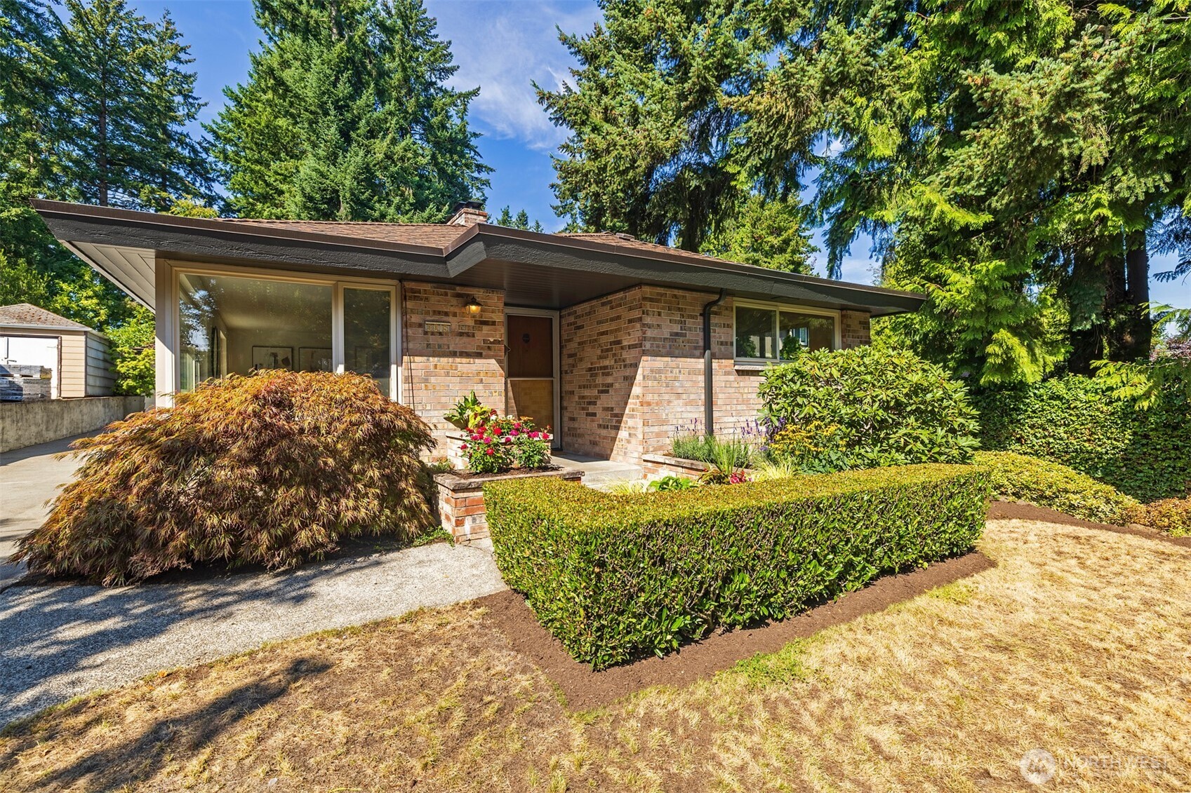A cherished time capsule, thoughtfully constructed to stand the test of time, this exceptional two-owner home has retained its original character and craftsmanship since 1963. Original details include warm wood paneling, custom built-in cabinetry, timeless bathroom tilework, retro light fixtures, and copper plumbing—beautifully maintained and full of authentic mid-century charm. Recent improvements—including newer double-pane windows, a newer roof, and central air conditioning—add modern comfort while complementing the home's enduring character. Set on a large lot, the property offers an exciting opportunity to update, expand, or personalize while preserving the distinctive details that make it truly special. Additional highlights include a detached two-car garage and a spacious lower level with high ceilings, a family room featuring a wood-burning fireplace, and abundant unfinished space ready to be transformed. A rare opportunity to own a home where original craftsmanship, retro appeal, and modern updates come together. Located in the Northern edge of Maple Leaf's shopping district, you are a stone's throw from coffee, Macrina Bakery, Judy Foo's Snappy Dragon, Ace Hardware and only moments from Northgate and I-5.