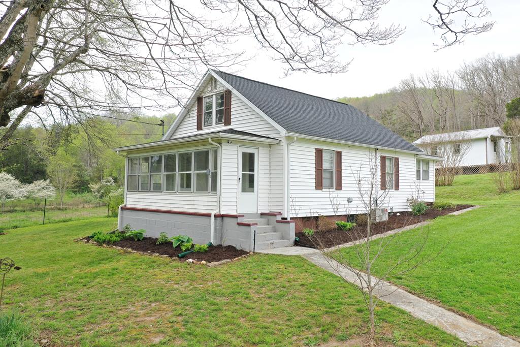 Come see this charming 3BR/1BA bungalow style home blending character and modern updates with beautiful mountain views! Enjoy the enclosed front porch, perfect for relaxing. The updated kitchen features granite countertops and stainless-steel appliances. Flexible floor plan includes a back room currently used as a laundry area that could easily be converted into a bedroom, mudroom, or craft space.  Approx. 800 sq ft unfinished basement offers excellent storage or potential for additional living space.  Great property for animal lovers or hobbyists! Features include a chicken coop with two separate runs, a small two-story barn ideal for a she shed, workshop, or storage (barn has electrical panel but currently disconnected), and a two-car covered carport that could be expanded to four cars or used for animal shelter. Fiber optic internet available.  Updates include: Roof, plumbing, septic system, central HVAC, hot water heater (all 2022), split HVAC system for upstairs with additional backup unit (currently off), and some electrical updates. Washer and dryer will not convey with the property. Buyer may conduct inspections; however, property is being sold as-is and inspections are for informational purposes only. Seller will make no repairs or cosmetic updates.  Don't miss this unique property with so much to offer.  Call to schedule your appointment to see this lovely property!  All information is deemed reliable but not guaranteed, buyer and buyers' agent to verify for omissions and errors. To ensure a smooth process, buyers are asked to submit proof of funds or a pre-approval letter before scheduling a showing.