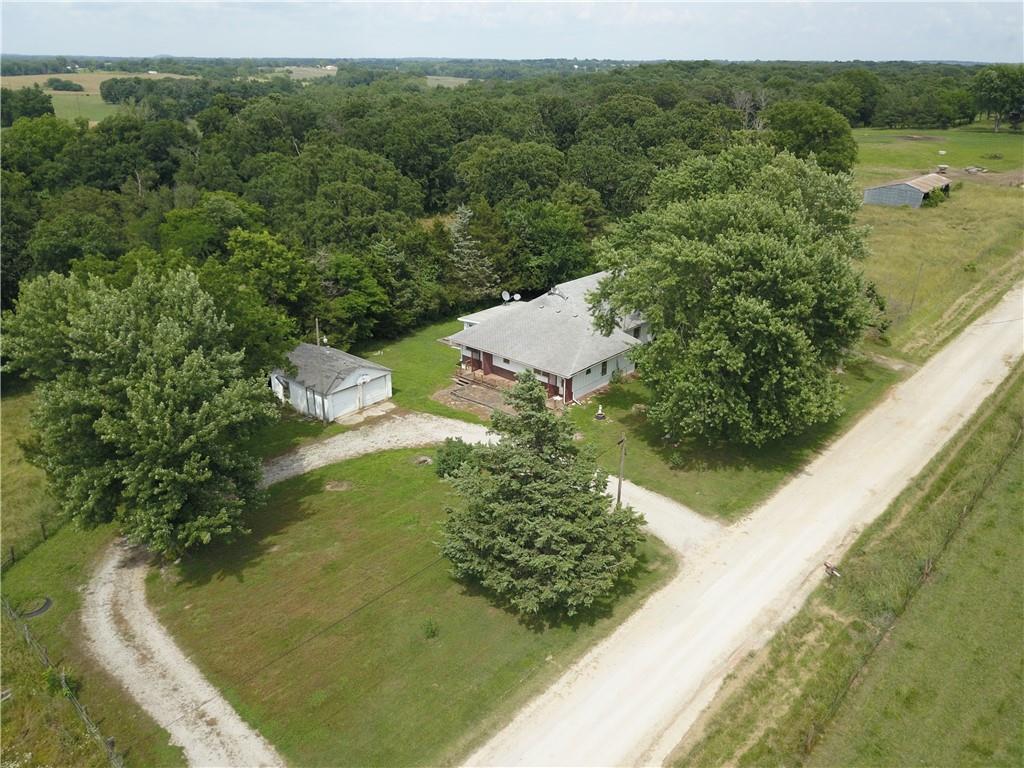 Less than a 3 minute drive from town and less than a 1/4 mile off blacktop, this 3 bed, 2 bath home sits at the top of the hill and overlooks a beautiful view of the pasture and valley. This property features 18.4 acres of mixed pasture and large hardwoods and 2 ponds. It is the perfect place for a small hobby farm as it is already fenced. Multiple gates around the property allow for easy access to the field.

The 3 bed, 2 bath house features two large bedrooms measuring 14x19.5ft and 13.5x19.5ft as well as a smaller third bedroom. 
There is a bonus room on the second level that could be used as a fourth bedroom. 
The large living room is very inviting and opens up to the dining room and kitchen. A second bonus room on the main level that could be used as an office. Laundry is also conveniently on the main level. 

At the back of the circle drive, there is a 20x24ft detached 2 car garage with electricity and a wood stove for heat. A 16x18ft carport on the other side of the home is also convenient for covering vehicles, mowers, equipment, etc. and there is a large 30x50ft equipment shed/loafing shed at the SW corner of the property.

Pictures don't do the view justice, come see this great property for yourself!