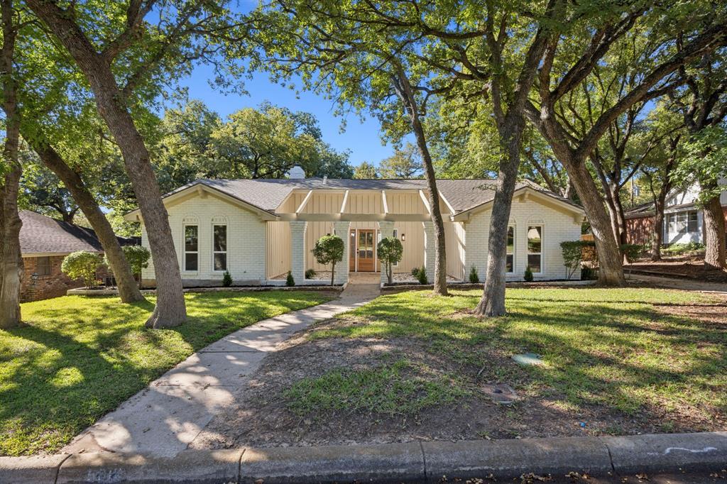 Welcome to 5016 Sugar Lake Rd, a beautifully renovated ranch-style home in the highly desirable White Lake Hills.Sitting on .288 of an acre with mature trees, this property combines timeless character with modern updates! 
Recent updates include new windows throughout, updated electrical. wiring and new electrical panel, interior remodel including flooring, cabinets, and fixtures, freshly painted exterior and interior finishes. 
Greeted by soaring vaulted ceilings with REAL wood beams and a dramatic stone fireplace that anchors the oversized living room. Freshly installed white oak-style flooring runs throughout, complementing the bright, open design. The flexible front room serves as a dining area, office, or playroom—tailored to your needs.
The sleek, fully updated kitchen includes all new shaker cabinetry, quartz countertops, and a black farmhouse-style sink. An electric range is in place, and the space is already plumbed for gas if preferred for cooking. Natural light from the backyard-facing windows, creating an inviting atmosphere for both cooking and entertaining.
This home offers three large bedrooms and three full bathrooms. The primary suite is a true retreat with dual vanities, a frameless glass shower featuring chic herringbone tile, and dual closets for generous storage. A Jack-and-Jill bath connects two secondary bedrooms, while an upstairs bonus room with a full bath offers versatility. The 2nd floor is ideal for a game room, guest suite, or private office with a large closet across the landing. 
Step outside to your oversized backyard, where towering trees provide shade and privacy—perfect for entertaining, gardening, or simply enjoying the peaceful setting.
With a spacious two-car garage and prime location near major highways, schools, and downtown Fort Worth, this home offers both convenience and tranquility.
Don’t miss the opportunity to own this move-in ready showpiece in White Lake Hills!