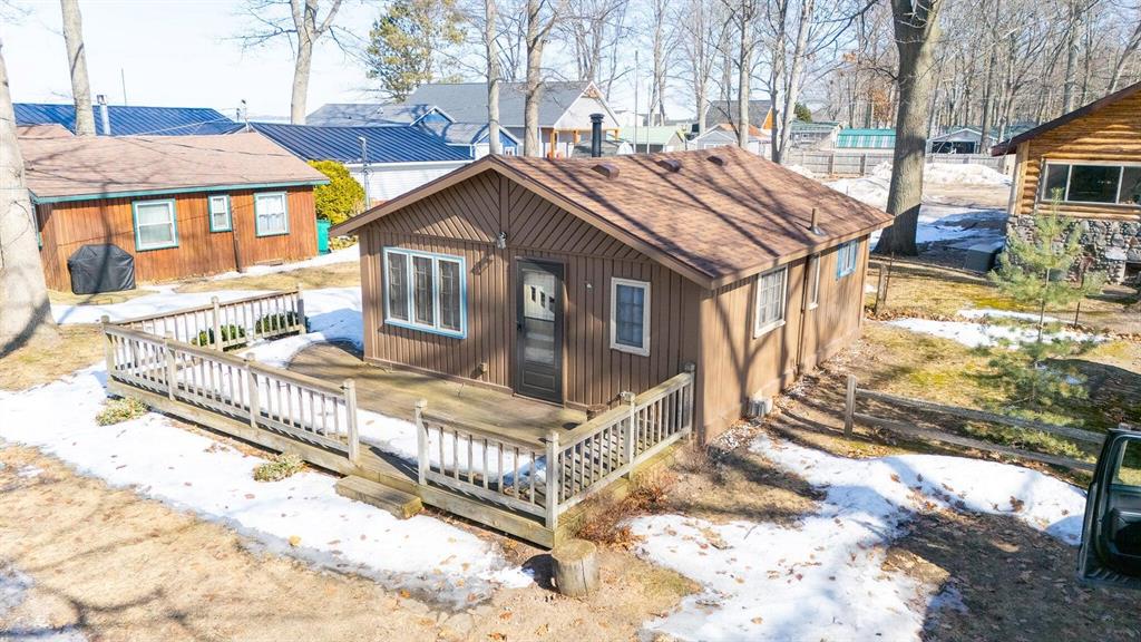 Well maintained cabin just steps away from the shared beachfront on beautiful Houghton Lake. Inside you will find a warm and inviting feel with tastefully decorated knotty pine walls that give it that true Up-North character. As Michigan's largest inland lake, Houghton Lake features sandy bottoms and plenty of all-sports activity year-round. The HOA includes docking rights, making it easy to get out and enjoy the water whenever you'd like. The Houghton Lake community also offers parks, events, and activities throughout both the summer and winter seasons. If you've been looking for an affordable way to enjoy direct lake access, this is a great opportunity. Properties like this don't come up often--don't miss your chance.