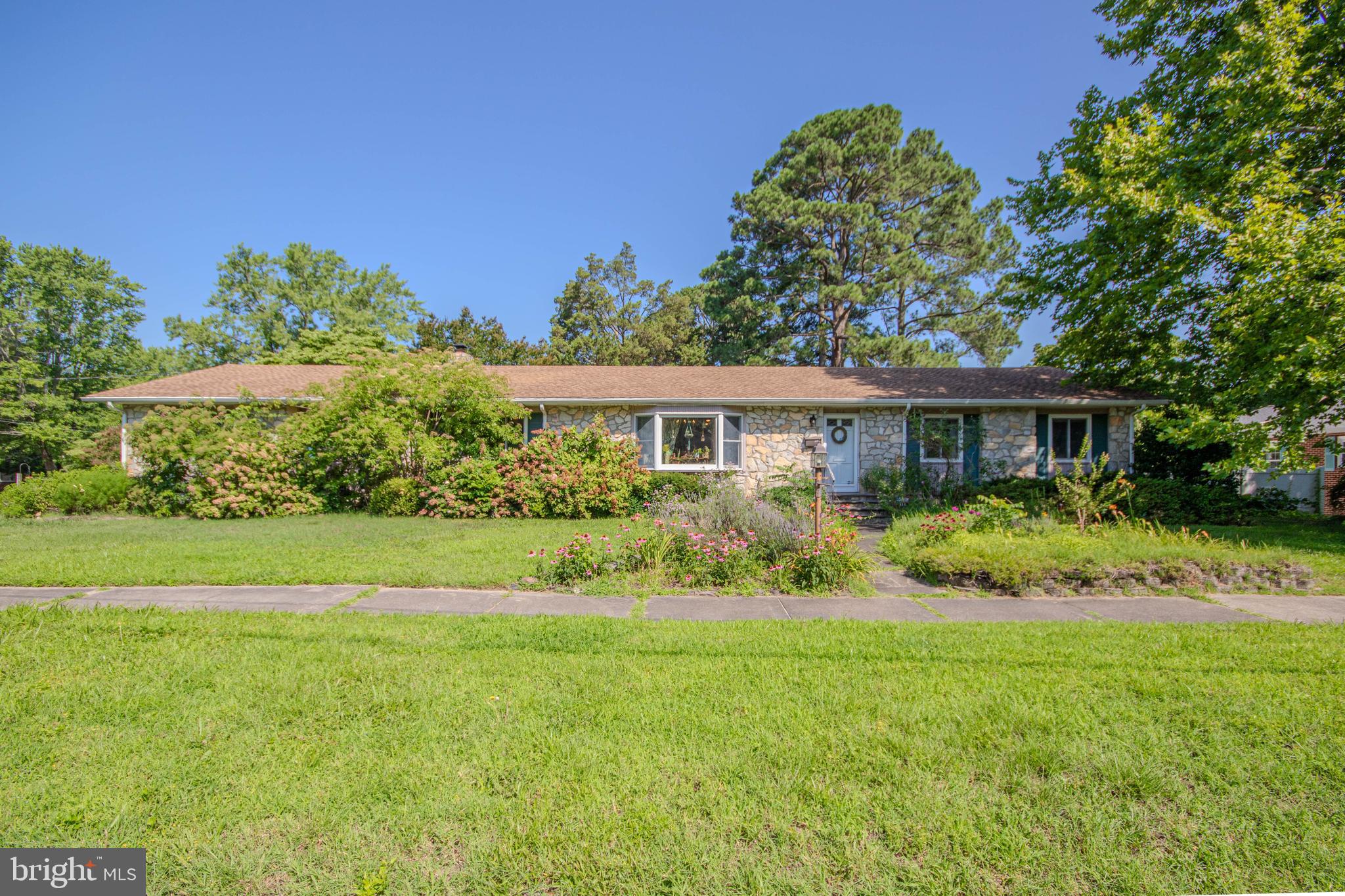 Welcome to 816 Riverside Drive, a spacious and well-maintained home ideally situated on a desirable corner lot in one of Salisbury's most convenient locations. Offering 3 bedrooms, 3 full bathrooms, and 3,609 square feet of living space including the basement, this property is just minutes from the University and Hospital. The thoughtfully designed open floor plan provides comfortable everyday living and effortless entertaining, featuring distinct living and dining areas along with a cozy family room highlighted by a wood-burning fireplace. The dining room offers a bay window that lets in an immense amount of natural sunlight, that you'll love! The first-floor primary suite offers convenience and privacy with its own full bathroom, while one guest bedroom and a full bath complete the main level. The fully finished basement expands the home's living space with a generously sized great room, one additional bedroom, full bathroom, built-in cedar wine cellar that also acts as a humidor, and utility room—perfect for recreation, hobbies, or accommodating guests. Additional highlights include an oversized attached two-car garage and a bright sun room overlooking the patio and beautifully landscaped private gardens. The backyard is enclosed with vinyl fencing and enhanced by an irrigation system served by a separate well, providing easy maintenance and year-round enjoyment. Combining generous living spaces, thoughtful amenities, and an exceptional location, 816 Riverside Drive offers the perfect blend of comfort, convenience, and charm.