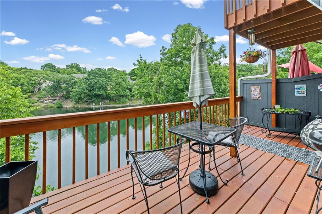 Want to feel like you are on vacation all year round? This Lakewood Bay townhome might be the answer! Home offers amazing views of the lake from every level. As you enter the home the main floor has a beautiful fireplace, large living room/dining room space, half bath, kitchen with an adjoining laundry facility and 2 sliding doors that open to an oversized deck with beautiful views of the lake. Upstairs has two large bedrooms with vaulted ceilings and a shared bathroom. The primary suite has a walkout martini/coffee deck which again offers unbelievable views and a great way to start your day or unwind in the evening. Let's not miss the walkout basement, this space offers a 3rd bedroom, private bathroom plus a stackable washer and dryer and a convenient kitchenette. Basement walks out to a covered patio which again offers peaceful views and convenient access to the docks and lake. Come take a look at Lakewood and all it has to offer, unbelievable community and close to everything!