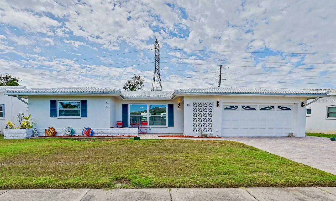 Just completed: a beautifully renovated 2-bedroom, 2 bath, bonus room, and 2 car garage with 1790 sq.ft. on the golf course, in the desirable 55 plus community of Mainlands of Tamarac by the Gulf. As you walk up the driveway, take notice that the pavers continue to the entrance of the home, providing a front patio area. Entering the home, you will see an open concept design of the living room, dining room, kitchen, and family room. The updated kitchen boasts a large, granite waterfall island, new stainless steel appliances, and plenty of white shaker, soft-close cabinets for all your cooking utensils. Off the kitchen is a door to an air conditioned, laundry room that includes an extra storage closet. Continuing through the dining room is the family room, plus a bonus room that can be used for an office space or craft room. There is a door from the bonus room to an enclosed covered, screened patio. All the rooms' light fixtures and fans have been updated. Flowing throughout the house is luxury vinyl plank flooring, with the exception of tile in the bathrooms. The primary bedroom has a walk-in closet and its own ensuite with a step-in shower. The guest bedroom at the front of the house has a large built in closet. Both bathrooms have been tastefully updated with new lighting, vanities, comfort commodes, tile flooring and fixtures. This property has impact windows for peace of mind. Residents of Mainlands Unit 4 enjoy access to a clubhouse with a heated pool, a library, and a variety of social activities: dances, card games, and shuffleboard. This is a golf-cart friendly community conveniently located just minutes from the Mainlands Public Golf course, Mayors Park, airports, and downtown St. Petersburg. This piece of paradise in the sun is waiting just for you. Hurry and schedule your private showing today!