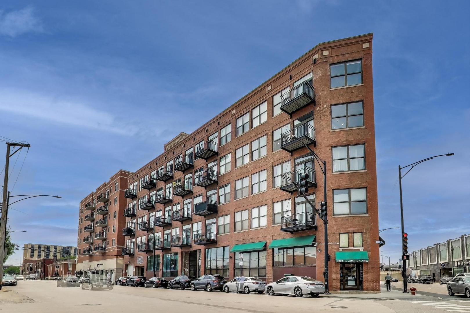 Step into a dramatic timber-loft masterpiece featuring 13-foot exposed ceilings, a corner layout with panoramic views, and sweeping wall-to-wall windows that flood every corner with light, capturing iconic downtown skyline views from the living room, bedrooms, and private balcony. At just over 1,400 sq ft, this sprawling splitplan corner unit blends loft-style openness with traditional comforts. The open-concept kitchen-with island, granite countertops, and stainless-steel appliances-seamlessly flows into the living/dining areas, ideal for entertaining. Rich hardwood floors run throughout, complementing the dramatic timber beams overhead. The oversized bedrooms feel serene, with ample space to accommodate large furniture and generous closet space. Baths feature spa-like touches: double vanities, separate showers, and a luxurious whirlpool tub. Enjoy modern comforts, including in-unit washer/dryer, central air, and a cozy fireplace. Deeded and heated garage parking is included, followed by an elevator ride to your unit for a seamless arrival experience. Guests and delivery personnel are a breeze, thanks to the Butterfly intercom system, which allows you to provide temporary codes to visitors.  Ideally situated in vibrant Chinatown, this loft delivers the best of urban living with CTA Red/Orange Line access within four blocks, easy highway connections, and proximity to the South Loop, lakefront, and local dining. Don't miss this striking home with some of the best views in Chicago.