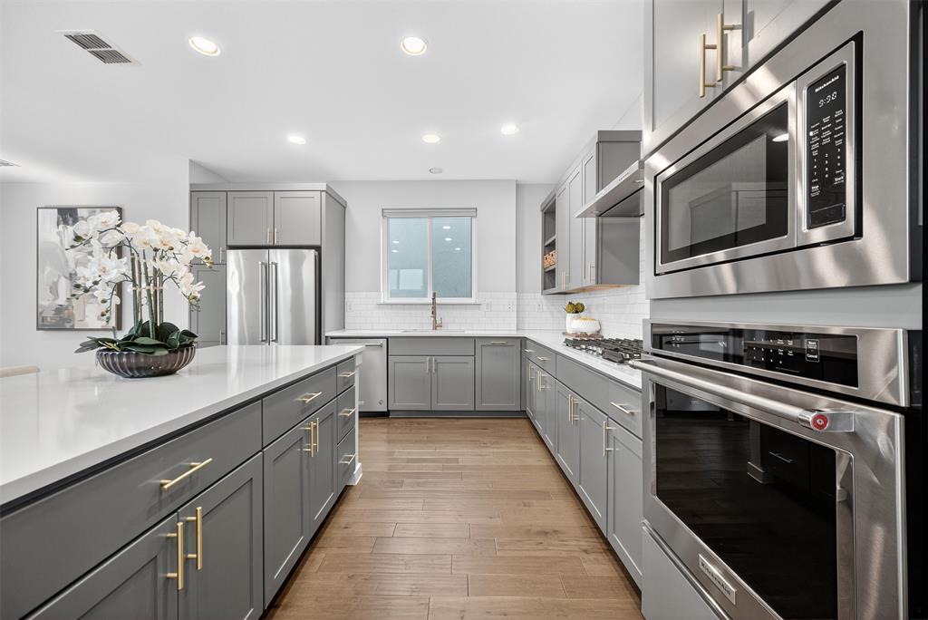 MOTIVATED SELLER! Modern style meets everyday convenience in this four-bedroom Dallas home, offering a flexible layout for work, guests, or play. Sunlit interiors feature tall ceilings, abundant natural light, and dual-pane low-E windows. The living and dining areas flow effortlessly into a chef’s kitchen outfitted with quartz countertops, ample storage, a generous island, and stainless steel appliances, a built-in bar, and wine fridge—perfect for entertaining or casual family nights. A cozy sitting area and a versatile downstairs bedroom, ideal as a guest suite or home office, complete the main level. Upstairs, warm wood floors lead you to a serene primary suite with a ensuite bath, dual sinks, and a walk-in closet. Two additional bedrooms, a flex room, a shared bath, and a full-size laundry room complete the second floor, offering both comfort and style for modern living. The backyard provides a private retreat with low-maintenance artificial turf, perfect for effortless entertaining year-round. Energy-efficient upgrades include Tesla 3kW solar panels, dual-zone HVAC, blackout shades, and a tankless water heater. Just steps from Glencoe Park, Greenville Avenue, and Mockingbird Station, with quick access to Downtown, SMU, and White Rock Lake, this home is also zoned to highly rated Mockingbird Elementary. A rare opportunity in one of Dallas’ most vibrant neighborhoods!