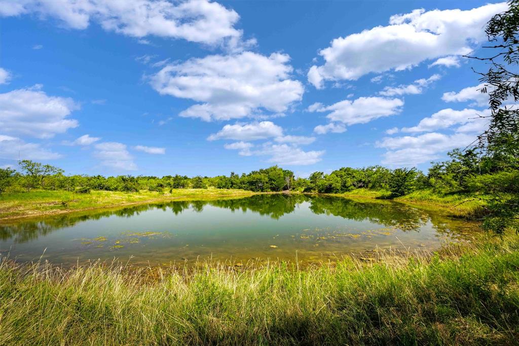 Enjoy the best of both worlds with this incredible 102 acre ranch located in Axtell ISD — just 2.6 miles off Highway 84 and minutes from the McLennan County Line. You’ll appreciate the peace of the country while being only 15-20 minutes from city amenities. This beautiful property offers a perfect mix of natural beauty and outdoor adventure. It features mature pecan trees, gorgeous live oaks and varied terrain:  heavily wooded areas, light woods  and open pasture. Four tanks—including a spring-fed pond and conservation tank and Christmas Tree Creek winds through the property. For those who like adventure, the property includes fun ATV trails that cut through the trees and along the creek. This is the perfect property for family, hunting, fishing or simply enjoying nature. Ideal for cattle, goats, and horses, this ranch is Ag Exempt and ready for livestock. Good tree cover for wildlife and lots lots of deer, hog and other game. The current owners have added thoughtful upgrades, including a water meter and a newly built his-and-hers bathroom, making it more comfortable for weekend visits or hunting trips. Whether you’re looking to build your dream home, create a recreational retreat, or enjoy the land as it is, this property is full of potential. Mt. Calm address, but located in the highly regarded Axtell Independent School District! This family ranch blends rural charm with modern convenience and offers a one-of-a-kind lifestyle just minutes from Waco and 4 miles from the McLennan County line. Ag Exempt, Axtell Schools, Prairie Hill Water installed, electricity on-site. No windmills on this property.