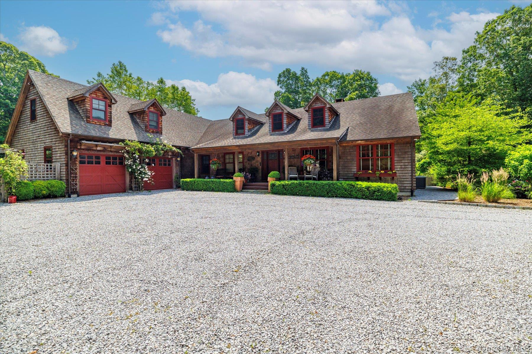 Secluded, Luxury Style Estate & Compound with Resort-Style Living In Serene Natural Setting

Set on nearly 5 private acres surrounded by the 400-acre Laurel Lake Preserve and bordered by state parkland, this expansive rustic-traditional Cape-style compound offers exceptional privacy and year-round comfort. With approximately 9,900 square feet of living space, the residence blends timeless design with a layout ideal for both entertaining and everyday living.

The home features 6 bedrooms, 5 full baths, and 1 half bath. At its center is a chef’s kitchen with premium appliances, center island, and a well-appointed butler’s pantry. Generous dining and living areas with 2 fireplaces flow seamlessly to the outdoors —including a screened-in porch, and wrap-around deck overlooking the beautifully landscaped lawn, backyard, and outdoor entertainment area.

The finished lower level offers walk-out access and includes a fitness studio, climate-controlled 2,250-bottle wine cellar, home theatre with built-in projector and sound system, home office, custom bar, and entertainment area with booth seating. A large bonus room above the garage and an unfinished attic provide additional flexible space with endless possibilities — perfect for a creative studio, private guest retreat, or future expansion.

Outdoors, resort-style living continues around the heated saltwater pool and spa, complemented by a 400-square-foot pool house with outdoor shower, dual-sided fireplace, built-in TV, fire-pit area, and custom outdoor grill. The landscaped grounds include space for a tennis court, a pond, private parking area near the entrance, and a network of private trails within the property perimeter leading directly to Laurel Lake Preserve hiking paths.

In addition to hiking, the scenic Laurel Lake Preserve is also considered a popular destination for fishing, canoeing, kayaking, and birdwatching — offering endless ways to enjoy nature just beyond your doorstep.

Additional features include a storage shed, partial fencing, and manicured lawns and gardens ideal for gatherings and leisure. Located just minutes from local farm stands, vineyards, golf courses, public beaches, the hamlet, restaurants, and public transportation, this secluded estate offers the ultimate North Fork retreat — combining natural beauty, recreation, and refined living.