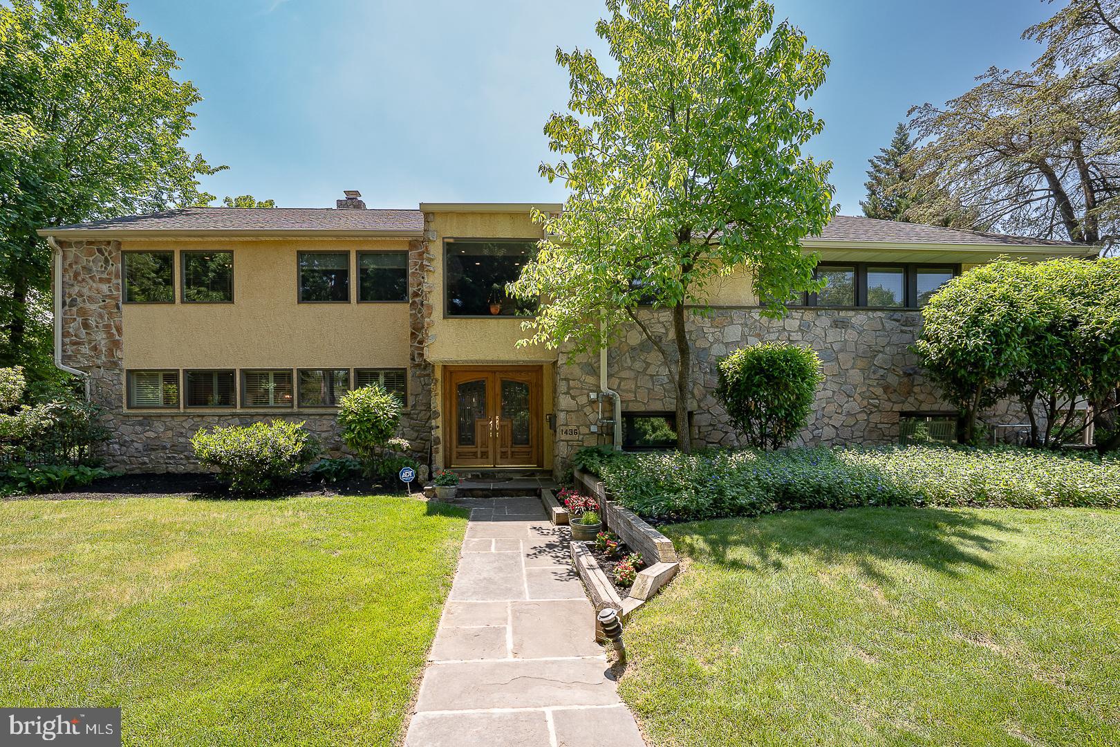 A custom-designed and welcoming 4-6 bedroom Wynnewood residence that truly “checks all theboxes,” offering a sophisticated yet comfortable lifestyle in one of Lower Merion’s most sought-after neighborhoods. Perfectly situated on a beautiful tree-lined street in the heart of the MainLine, 1436 Hillside Road combines timeless character, generous living spaces, and exceptionalamenities for today’s lifestyle.From the moment you enter the leaded glass double doors, it is immediately apparent you areentering a very special home. The dramatic vaulted stone-walled foyer opens to the upper-levellanding highlighted by an elegant custom brass and metal railing, creating a striking architecturalfocal point.The main level offers an ideal blend of gracious entertaining spaces and comfortable everydayliving. The spacious Living Room features rich wood flooring, a stunning brick accent wall, anda corner fireplace, flowing seamlessly into the grand Dining Room with French doors leading tothe rear patio and backyard oasis.The expanded and beautifully remodeled Kitchen is truly the heart of the home and a chef’sdream, featuring a large quartzite island, beverage center, mini office area, abundant cabinetry,and exceptional workspace. Adjoining the Kitchen is a sun-filled Breakfast Room with vaultedceilings and Plantation shutters overlooking the beautifully landscaped grounds.Designed for both entertaining and relaxation, the fully fenced rear grounds offer a resort-likesetting complete with a stamped concrete patio, heated swimming pool, built-in gas grill, andstorage shed.The walk-out Lower Level serves as an exceptional Recreation and Family Room featuringporcelain tile flooring, a remodeled Powder Room, dramatic full stone wall with fireplace andslate sills, plus a wall of windows overlooking the rear yard. The Laundry Room includes built-in cabinetry, utility sink, and second refrigerator. Access to the attached Garage leads directly tothe expansive three-car carport.The third level offers four Bedrooms, including the luxurious Primary Suite with professionallyoutfitted walk-in closet and renovated ensuite Bath featuring double vanities, quartz countertops,oversized shower, and tiled flooring. Three additional Bedrooms are spacious and wellproportioned. The tiled hall Bathroom includes a double sink vanity and tub/showercombination.The top level provides incredible flexibility with two additional Bedrooms, one currently used asa home office featuring vaulted ceilings and skylight. A beautifully tiled hall Bath includes aJacuzzi tub positioned beneath a skylight. Completing this level is a second Recreation/FamilyRoom with dramatic vaulted ceilings, two Casablanca “Stealth” ceiling fans, dual skylights,storage closets, and surround sound wiring throughout the entire level. This inviting space is theperfect retreat for relaxing, entertaining, or enjoying movie nights.Additional features include a large floored attic with cedar closet, beautiful wood flooring,recessed lighting, Plantation shutters, abundant windows providing natural light throughout, six-zone heating, and three-zone central air.Impeccably maintained and thoughtfully updated throughout, this exceptional home offers aneasy flowing floor plan, spacious rooms, and the perfect balance of elegance, warmth, andcomfort.Ideally located within award-winning Lower Merion Schools and just minutes to the R-5 train,Suburban Square, Whole Foods, Trader Joe’s, fine dining, Center City Philadelphia, and theWestern Suburbs.Many furnishings may be available for purchase.