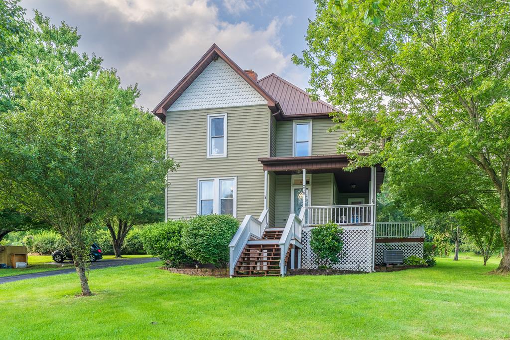 Step into the timeless charm of this beautifully updated 4-bedroom, 2-bath farmhouse in the heart of Rural Retreat! Rich with original character and classic farmhouse appeal, this inviting home perfectly blends historic charm with today's modern conveniences. From the welcoming covered front porch to the spacious interior, you'll feel right at home the moment you arrive. Inside, you'll find four spacious bedrooms, including a versatile main-level room that can serve as a bedroom, home office, or flex space to fit your lifestyle. The home also features a comfortable living room, formal dining room, and a completely remodeled country kitchen that combines modern finishes with timeless farmhouse style. The private primary suite offers a spacious ensuite bath with a soaking tub, separate shower, and conveniently located laundry area. Throughout the home you'll appreciate the abundant storage, large rooms, and preserved architectural details that give this home its unique character. Situated on approximately 0.61 acres, the property also includes a paved driveway, detached garage, and workshop—perfect for hobbies, projects, or additional storage. Relax on the covered front porch while taking in scenic views overlooking the town of Rural Retreat. Conveniently located near local shops, restaurants, schools, and I-81, this home offers the perfect combination of small-town charm, modern updates, and everyday convenience. Don't miss this rare opportunity to own a beautifully updated farmhouse with room to grow—schedule your private showing today!