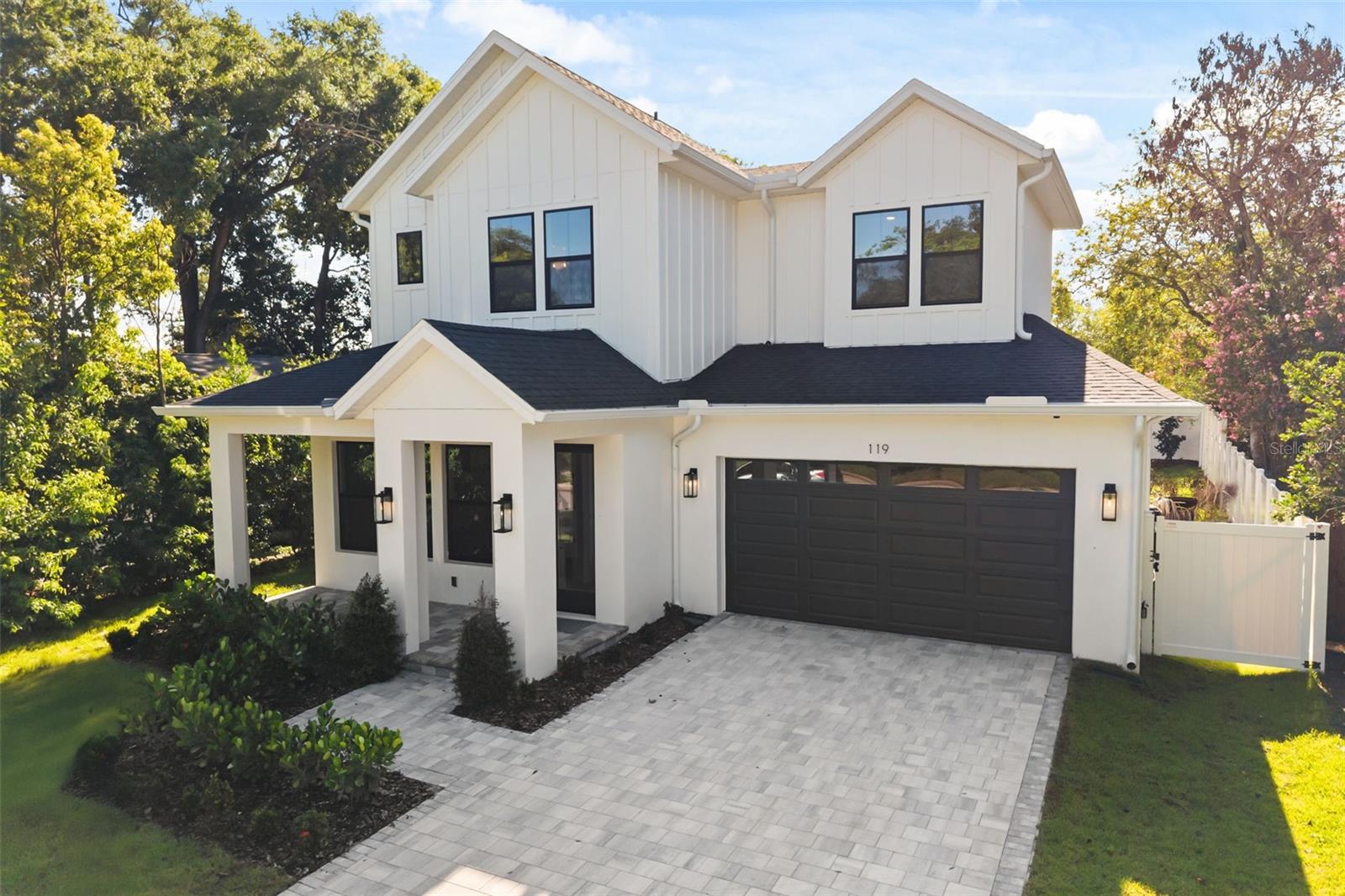 Virtually Staged. This stunning, newly built custom home not only has curb appeal, it boasts of opulence from the moment you enter inside.  Located in the Milk District, it is in the heart of downtown Orlando.  This 5 bedroom, 4 bathroom, 2-car garage home has 2,845 square feet of functional living space.  The Primary Bedroom is located on the first floor, along with a secondary bedroom with ensuite bathroom and a walk-in closet, which could be utilized as an office, a study, den or library In lieu of a bedroom.  The second story has three large bedrooms with walk-in closets, and two full bathrooms.  The Kitchen was designed to please a Chef, with tons of countertop area for prepping, and Thermador appliances, which include a 5-burner gas cooktop, stainless steel hood vent, a built-in oven/microwave, dishwasher, and a French door refrigerator.  The kitchen cabinetry extends to the 10’ ceilings, with additional cabinets on the back side of the island, as well as having a large walk-in pantry closet with built-in custom shelving!!  The great room design is exceptional for daily interactions, entertaining or hosting events.  Open the sliding glass doors and you can overflow to the lanai and large private backyard.  The Builder has pool renderings, to showcase how the backyard would look like if you add a pool in the future. The designer spared no details, from the custom trim work that greets you in the foyer and entrance hallway, to the crown moulding and large baseboards; from the lavish finishing selections in the kitchen, to the posh details in the primary bedroom and bathroom.  The secondary bedrooms and bathrooms are finished with as much attention to details as the primary!!  The details in this home are countless: extensive custom trim work; 10’ ceilings on both floors; 8’ doors; engineered wood flooring; porcelain tile bathroom & laundry/utility room flooring, shower & tub surrounds; custom cabinetry with soft close cabinet doors and drawers throughout the home; expansive covered lanai with pre-plumbing for a future summer kitchen; tongue & groove wood ceilings on the front porch and rear lanai; paver driveway, lead walk, front porch and rear lanai; board & batten front elevation; epoxy garage floor; irrigation system; pre-wiring for a future pool; PVC privacy fenced yard; gutters & downspouts; low voltage pre-wires; security system; etc.  We can go on and on, but honestly, this home has to be seen to be truly appreciated!!  Not-to-mention that the location is phenomenal!!  Centrally located, it allows easy access to major highways, dining, entertainment, sporting events, hospitals, Lake Eola, parks, shopping and more!!  Schedule an appointment to view this home while you can !!