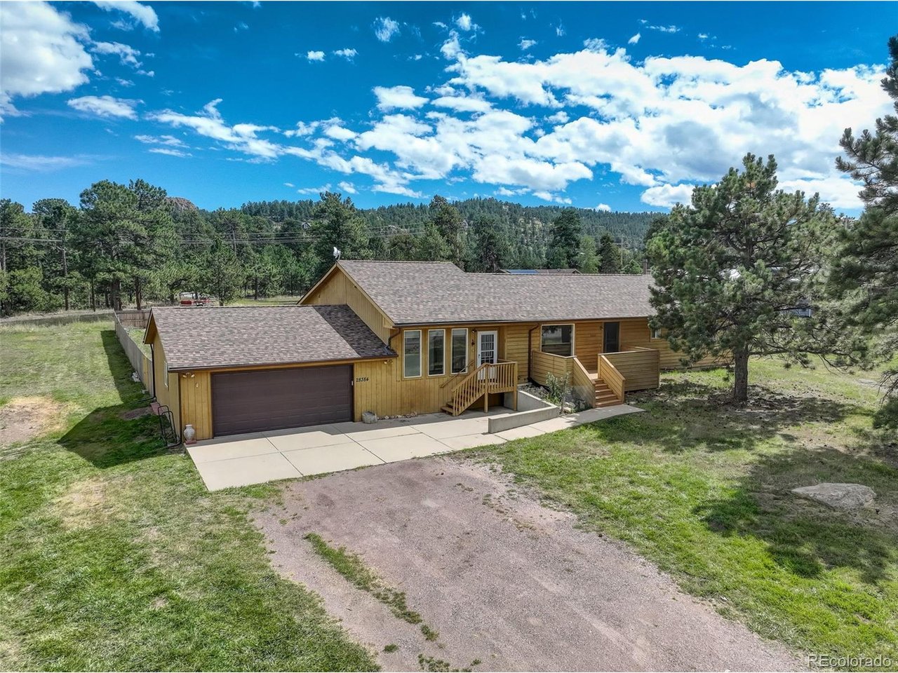 RANCH MULTIGENERATIONAL HOME ON USABLE DOUBLE LOT WITH AWESOME VIEWS!!! ~ Peaceful mountain living close to Highway 73 for easy access to Evergreen & Conifer. Nearly 1 acre of flat, usable land with large, fenced area. Awesome views of Bergen Peak, Squaw Mtn., Evergreen Mtn., Mt. Judge & Saddleback Mtn.~ This lovely 4 bed, 3 bath, 1,878 sq ft ranch home with dual primary ensuite bedrooms is perfect for multi-generation living. The open main floor is light & bright with vaulted ceilings. Entertain family & friends on the large deck while enjoying the outdoor mountain lifestyle. ~ Great floorplan for easy living & entertaining with living room flowing into dining room, deck & kitchen. Separate bonus wing off kitchen feature sunroom, bonus room (for office, nursery, gym) & ensuite bedroom. The additional ensuite bedroom, bathroom & 2 additional bedrooms are located on the other side of the home. ~ Oversized heated garage with utility sink. Newly fenced rear yard with large shed & hen house. Plenty of room for all your RV, boat & mountain toys. Newer (2022) high-impact class-4 roof.~ County maintained roads, top school & near school bus stop. Community water & 3 bedroom septic (for 6 people). New septic tank to be installed prior to closing. ~ Only 30 minute drive to Denver, 1 hour to airport & 1 hour to ski resort. Close proximity to 285, supermarkets, restaurants & trails. Welcome to your perfect mountain home! **** Please note, this wonderful home, with many original features, is perfect for buyer's own touches. The decks & stairs need some refurbishment & home is priced accordingly.
