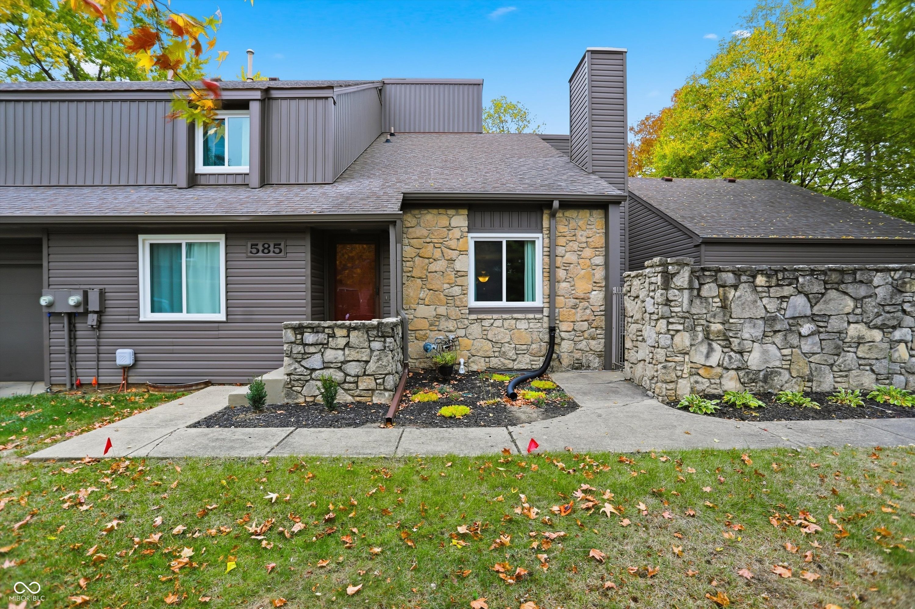 585 Conner Creek DR, FISHERS, IN presents an inviting home, ready to move in and begin a new chapter. This condominium offers a delightful blend of low maintenance living and desirable features including community pool, tennis courts, clubhouse, walking trails through mature trees, setting the stage for a relaxed and fulfilling lifestyle.  The living room makes an unforgettable first impression with its soaring high ceiling and vaulted ceiling, creating an airy and expansive atmosphere perfect for both relaxing evenings and lively gatherings. Imagine sunlight streaming through the windows, illuminating the generous space and highlighting the architectural details that make this room truly special.  The kitchen is thoughtfully designed with shaker cabinets and a tray ceiling, adding a touch of elegance and sophistication. A kitchen peninsula provides additional counter space, making meal preparation a breeze while offering a convenient spot for casual dining or entertaining.  Beyond the interior, discover the pleasure of outdoor living with a private patio, perfect for enjoying morning coffee or evening cocktails. An outdoor dining area extends your living space, inviting you to savor al fresco meals and create lasting memories with loved ones.  This residence offers the convenience of a laundry room and the luxury of a walk-in closet, providing ample storage and organizational solutions. With three full bathrooms and two bedrooms, comfort and convenience are thoughtfully integrated into every aspect of this home's design.  With 2,344 square feet living area across 2.5 levels, this property is a perfectly balanced haven ready to become your dream home. Many recent updates including HVAC, Water Heater, Windows/Ext Slider, basement water proofing (transferable lifetime warranty), sump pump and battery back up, Exterior Siding *Assessment Fully Paid*