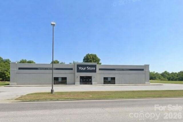 This 18,000± square foot retail building offers a highly visible, single-story presence along a main thoroughfare, making it an exceptional opportunity for investors or owner-users seeking scale, accessibility, and exposure.The building features a clean, modern façade with strong curb appeal and prominent signage potential, set well back from the road for clear sightlines and easy access. A generous surface parking lot supports high customer volume, while multiple storefront-style entrances allow for flexible use—ideal for a single large-format retailer, showroom, fitness concept, grocery, or subdivision into multiple tenants.The rectangular footprint and wide frontage lend themselves to efficient interior layouts, adaptable merchandising, and straightforward reconfiguration. Positioned in a growing commercial corridor with steady traffic counts, the property benefits from surrounding retail, service businesses, and residential neighborhoods.This is a rare opportunity to acquire a large, freestanding retail asset with visibility, parking, and flexibility—well suited for repositioning, redevelopment, or long-term income generation in a prime location.