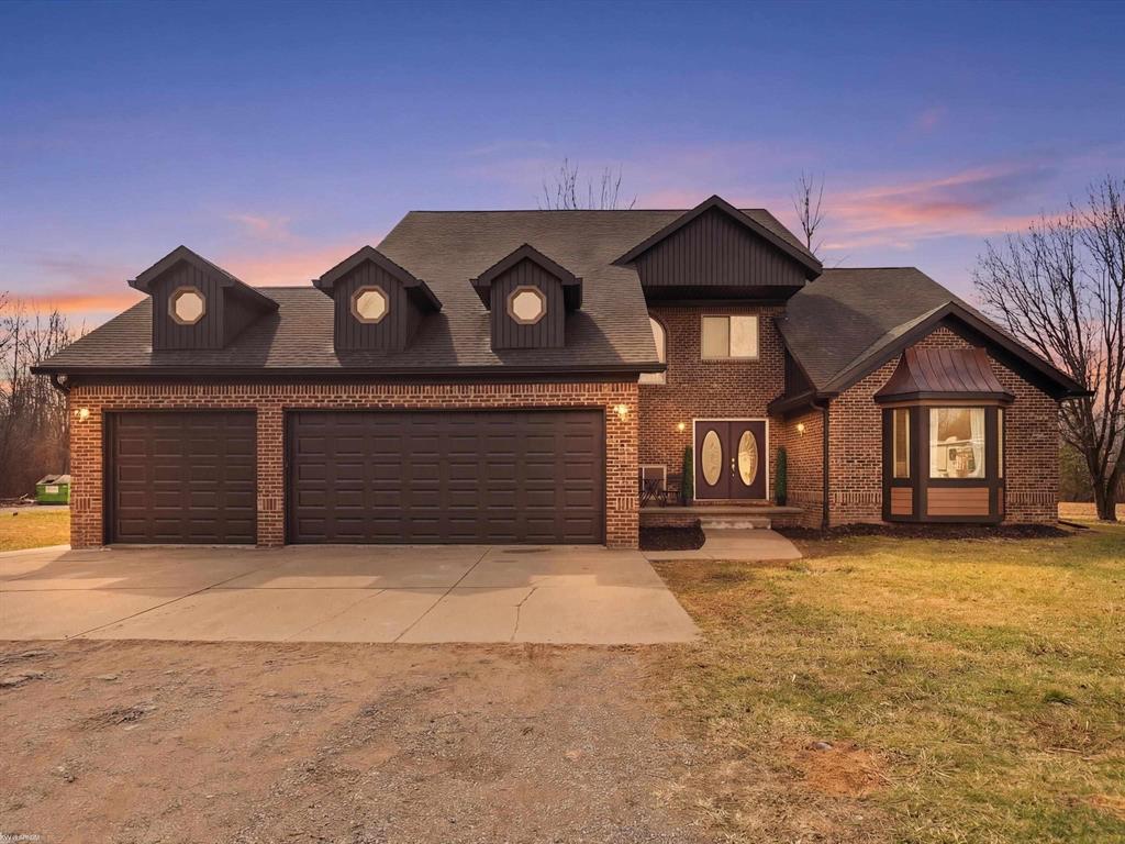 Beautifully updated brick split-level home situated on 10 private acres, set well back from the paved road for exceptional privacy. Conveniently located with easy access to I-94 just 7 miles away, while shopping centers and two medical hospitals are within 5 miles. Lake St. Clair is only 2.5 miles away an ideal location for lake lovers.  This spacious home features 4 bedrooms and 3 full bathrooms, including a primary suite with a walk-in closet and private walkout access to the deck. A convenient entry-level home office makes working remotely comfortable and practical. Hardwood floors add warmth and character throughout the main living areas.  The updated kitchen is designed for both everyday living and entertaining, featuring waterfall granite countertops, a matching granite dining room table, stovetop, and double oven. The dining area also offers walkout access to the deck, creating a seamless indoor-outdoor flow perfect for gatherings. The finished basement provides additional living and storage space, including a room with double closets ideal for organization, storage, or flexible use. Outside, the property is designed for outdoor living and recreation. Enjoy a large entertaining deck, volleyball court, and a private fishing pond.