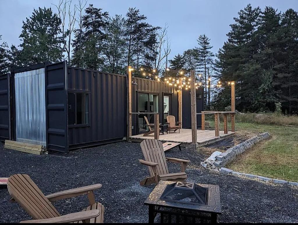 Rare opportunity to own two modern tiny homes on over an acre of ridge top land stunning mountain views. Each home offers a full kitchen and full bath with tile walk-in showers. Perfect for multi-family living, short term rentals, or a combination of both. Built in 2024 with structural steel reinforcement for added strength against snow and wind, these homes were designed for durability, comfort, and efficiency. Enjoy high-speed internet, smart home automation with upgraded electrical switches and modern finishes throughout. This property features a covered outdoor patio bar with 65" TV, fire pit with mountain views, RV hookup, and newly planted fruit trees. One of the homes has a proven Airbnb history with 5-star reviews. A new well and septic system are in place, and the property is surrounded by larger farms offering peace and privacy. Located less than 5 minutes from Lovills Creek Lake and just minutes from the Blueridge Parkway. This property combines modern, low maintenance, and tranquil living. Low county taxes and move-in ready furnishings included!