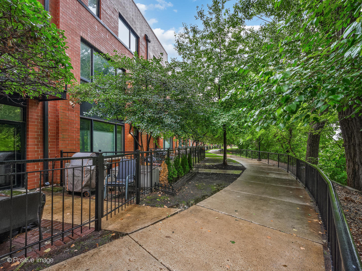 Stunning and chic 4-story riverfront townhome that lives like a single-family, nestled at the crux of Bucktown/Logan Square with idyllic views of the Chicago river! An extra wide 2900 square foot floor plan allows for the rare four bedrooms and three full bathrooms up! Enter your main level from a charming brick paver patio along the river walk to the family room with wet bar, new mudroom with custom built ins, new flooring, a large walk in storage closet and the convenience of an attached two car garage. The airy second level boasts 10' ceilings, a fully upgraded kitchen with white cabinetry, newer stainless appliances, quartz counter tops and subway backsplash. Tree top and river views bathe the open concept living/dining room with a brand new chevron stone fireplace surround, a navy paneled accent wall, updated lighting and hardwood flooring. The updated powder room and laundry complete the second level. Third level boasts a massive, fully renovated primary suite with an incredible walk in dressing room the size of most bedrooms and a totally overhauled primary bath with dual vanities, stone floors and a glass enclosed walk in shower. An en suite guest bedroom houses an upgraded second bathroom with brand new flooring and upgraded vanity. Top level boasts two spacious bedrooms, a third updated bathroom with penny tiled floors and upgraded vanity and a flex work space that walks out to the roof deck with trex decking. Throughout the home, you will find luxe transitional finishes-including updated hardwood, porcelain and stone flooring, light fixtures, new hot water heater, AC, furnace and recently replaced roof & Trex roof deck. Nothing to do but move in an enjoy life along the river front path conveniently located on a quaint tree lined street, steps from Hexe Coffee, Midtown Health Club, Fresh Thyme Market, Hamlin Park, Target, Costco, and Binny's.