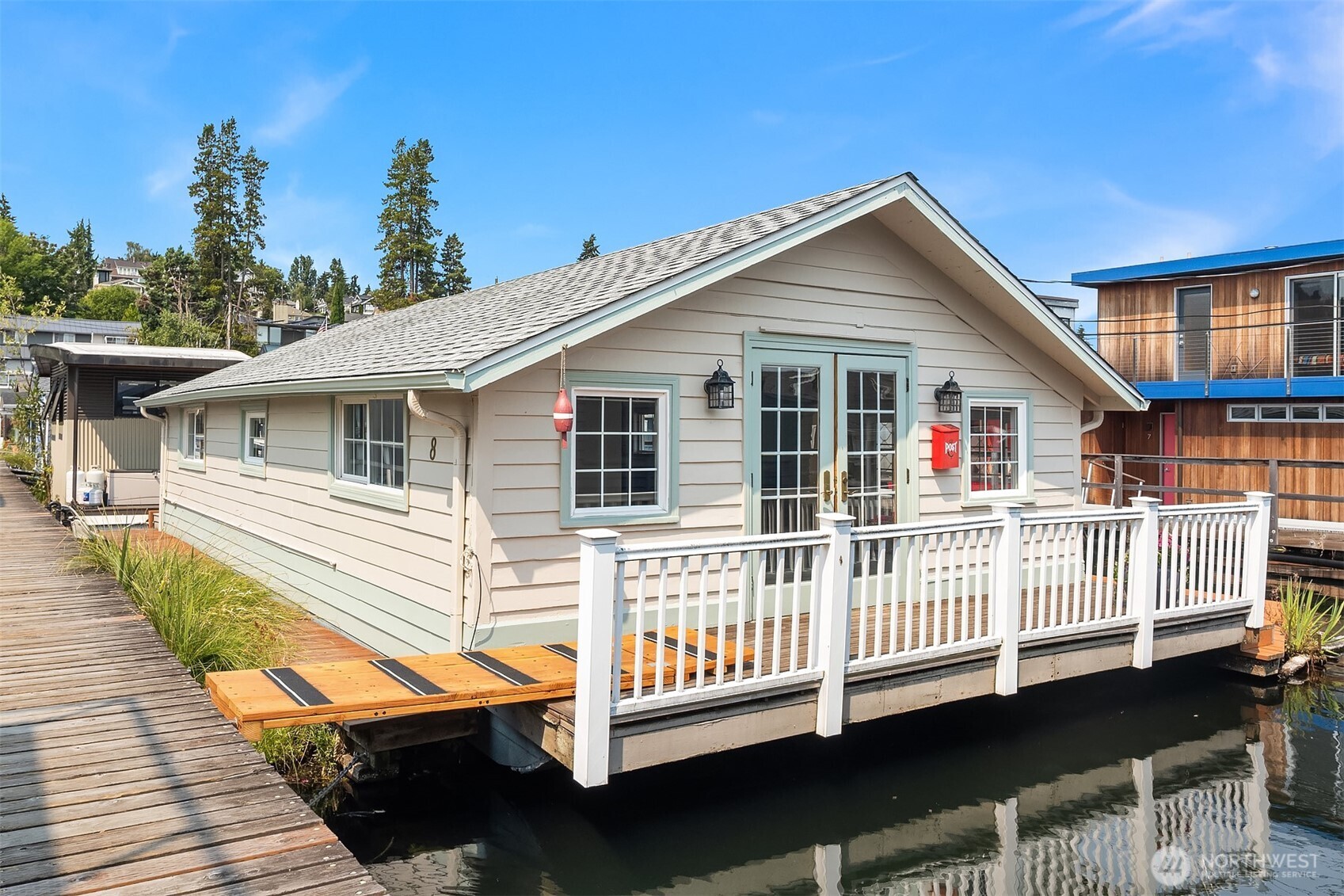 First time on the market in more than 30 years, this floating home in a 51' wide slip with dedicated parking space offers a rare opportunity to own a piece of Seattle's iconic waterfront lifestyle on coveted Portage Bay. Affectionately known as *Fleetenhus*, this quintessential Scandinavian-inspired floating cottage captures the simple beauty of life on the water, where every day begins and ends surrounded by the sights and sounds of the bay. The efficiently designed two-bedroom, one-bath home has been refreshed with a new roof, fresh interior & exterior paint, new carpet, and new appliances, creating a welcoming retreat ready to enjoy today while offering the opportunity to personalize over time. What truly sets this home apart is its exceptional relationship to the water. Generous wraparound overwater decks create an expansive outdoor living environment that feels immersed in Portage Bay, offering abundant space for dining, entertaining, relaxing, or simply watching changing light dance across the water. A small boat slip with channel access makes it easy to head out for a paddle or cruise.  Ownership includes the cooperative dock slip and dedicated parking space. Rarely does a floating home with this combination of history, character, generous outdoor living, coveted location with room to expand become available. An exceptional opportunity to become part of one of Seattle's most treasured waterfront communities with easy commute options via H2O, 520 or I5!