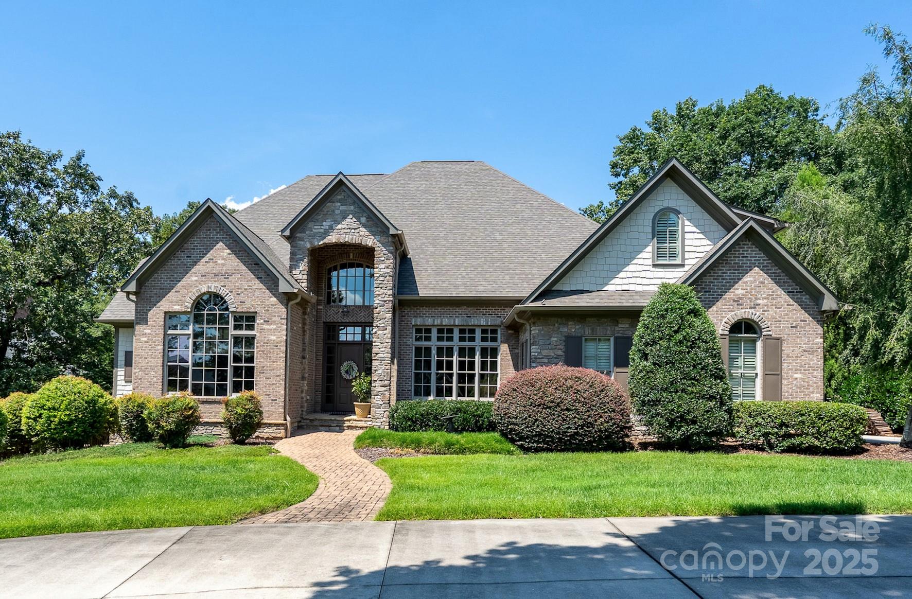 This spectacular home within the Old North State Club community is situated on a generous sized lot with serene golf course views & an open floorplan that checks all the boxes. The kitchen is a chef's dream with top-of-the-line appliances including gas range, double oven & walk-in pantry with twin wine fridges. Off the impressive two-story entryway are the stately office & a formal dining room. The kitchen flows to a sunny breakfast room & vaulted Great Room with fireplace, perfect for entertaining & hosting. Relax on the screened-in porch overlooking the lush golf course. Owner's suite with fireplace leads to a luxurious bath with his & hers walk-in closets. Members of Old North State Club enjoy access to one of North Carolina's top golf courses, full-service marina, tennis/pickleball courts, exercise classes, fitness center & dining. The property's location offers a peaceful & private setting while being just a short drive from Charlotte, the Triad & the Triangle.