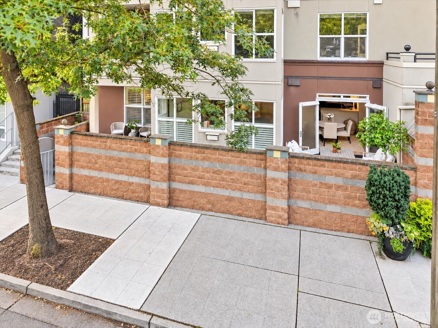 Highly desired and rarely available, this beautifully updated McKee Parkside boutique residence offers the rare combination of private street-level gated entry as well as lobby access! Sophisticated yet cozy interiors and lovely views of Downtown Bellevue Park including winter views of the city. Open living spaces showcase contemporary finishes, newer hardwood-style flooring, 2nd bdrm/office, and inviting living room with gas fireplace and beautiful built-in shelving.  French doors opening to a private patio—perfect for relaxed entertaining and/or enjoying the park-side setting. The kitchen features elegant cabinetry, gas cooktop, granite surfaces and stainless steel appliances including wine/beverage fridge, and the spacious primary suite offers a spa-inspired bath w/jetted tub, & walk-in closet. Central A/C & heat offer comfort all year long! Exceptional convenience with two secure garage parking spaces and a private storage unit. Building amenities feature an outdoor pool, hot tub, fitness center, club room, and guest suite, not to mention a gorgeous courtyard and beautifully landscaped grounds. With no rental cap and pet friendly, enjoy flexibility as an upscale primary residence, or long term investment.  Just steps from Old Bellevue dining, wine bars, cafés, boutiques, Bellevue and Lincoln Squares, waterfront parks, and world-class shopping & entertainment - this property checks all the boxes!  Comfortable urban living one of downtown Bellevue’s most coveted locations!