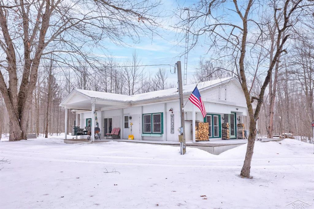 Escape to pure Northern Michigan living on 39.66 private acres at this beautiful  property in Turner. Surrounded by nature and wide-open space, this home is ideal for outdoor lovers, hobbyists, and anyone seeking peaceful country living  The house features warm tongue-and-groove cedar throughout, delivering a cozy, rustic charm that never goes out of style. Step outside and explore groomed trails winding through the property-perfect for walking, riding, or enjoying the land in every season. The acreage is loaded with wild raspberries and blackberries and is known for incredible deer right on the property, making it a prime spot for wildlife watching and hunting.  A standout feature is the fully insulated, and Heated pole building, ideal for storage, a workshop, recreational vehicles, or a home business. With 220-amp power, it's ready for serious equipment and future growth.  Whether you're looking for a full-time residence, a recreational getaway, or a Northern Michigan hunting retreat, this property delivers privacy, space, and outstanding outdoor potential.  Nearly 40 acres like this don't come available often-schedule your showing today.