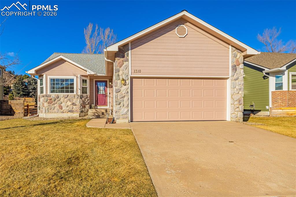 Located in the highly desirable Rockrimmon area of Colorado Springs, 1310 Bison Ridge Lane offers low-maintenance living in the quiet Eagles Nest neighborhood, just steps from Ute Valley Park and its exceptional hiking and biking trails. Exterior landscaping is maintained by the community, allowing you to enjoy the surroundings without the upkeep. A brand new roof adds peace of mind from day one.  This ranch-style home features vaulted ceilings and hardwood floors throughout the main level, creating a bright and inviting atmosphere. The main living area is centered around a beautiful stone gas fireplace, while the remodeled kitchen showcases granite countertops, elegant gold accents, and a layout ideal for both daily living and entertaining.The main level includes two bedrooms, including a spacious primary suite with direct walk-out access to the backyard, a beautifully updated primary bath, and a large walk-in closet. A functional mud room connects to the two-car garage and includes a washer and dryer, laundry sink, and additional cabinetry.  The finished basement is perfectly designed as a secondary living area, featuring Luxury Vinyl Plank flooring, a large family room with a stone-surround fireplace, and a secondary kitchenette with pantry. A second set of washer and dryer with an additional laundry sink adds flexibility and independence to the lower level. The basement also includes a large third bedroom, bringing the home to three total bedrooms.  With its prime location, thoughtful updates, and versatile layout, 1310 Bison Ridge Lane offers comfortable living in one of Colorado Springs’ most sought-after neighborhoods.