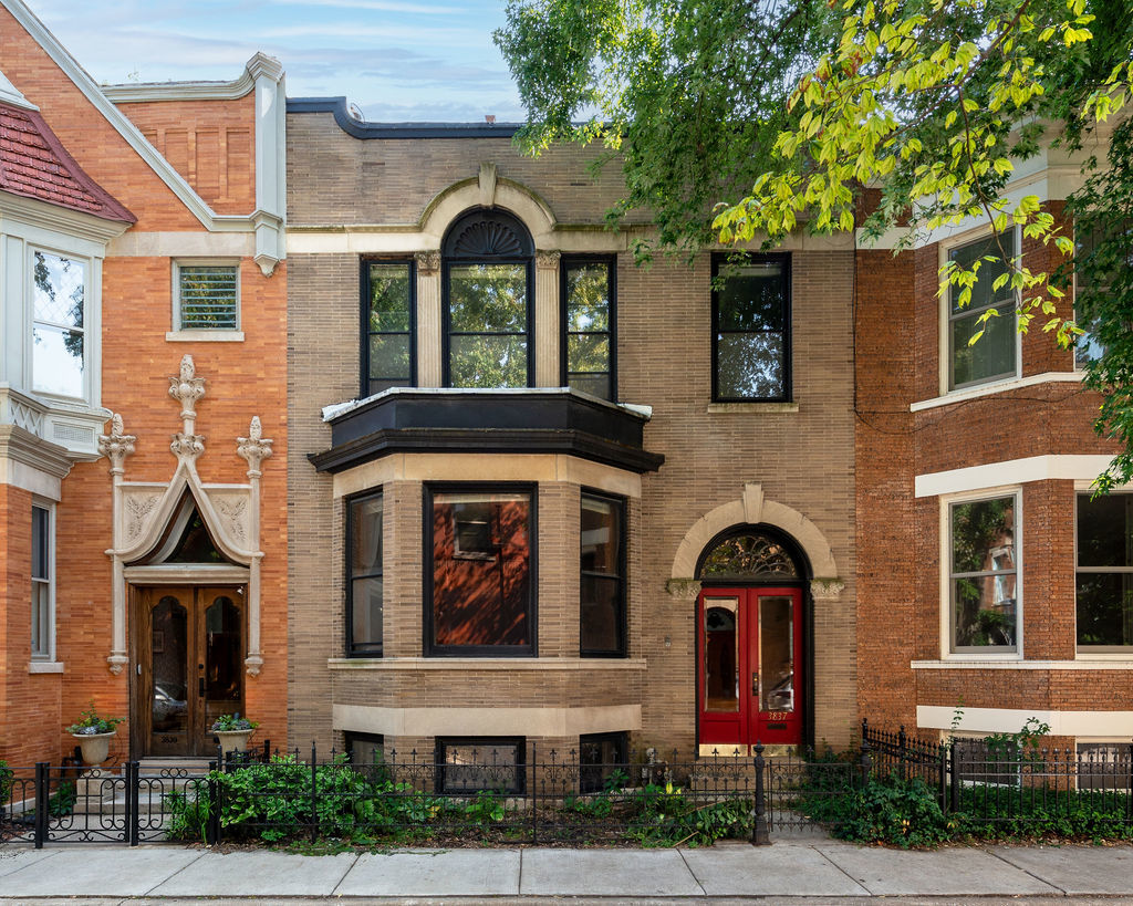 Step into Chicago history on one of the city's most enchanting and historic blocks, Alta Vista Terrace. Tucked away in Lakeview, this stately rowhome offers exceptional livability and walkability in an iconic setting. Designed by Joseph C. Brompton, and developed by Samuel Ebberly Gross from 1900-1904 as one of his last developments, each of the 40 London-style rowhomes have an identical residence diagonally from it with their own unique architectural features (this home and its twin are most notable for their central Palladian windows on the second floor). Built in 1901 and rich in original architectural details, the home features beautifully preserved millwork, hardwood floors, and period moldings throughout. The living room features tall ceilings, a cozy fireplace, and a stunning bay window looking out onto the street and amazing western sunlight. The kitchen was reimagined into an open concept kitchen/dining area with custom cabinetry, Quartz countertops, stainless steel appliances, and a large center island perfect for entertaining. Hidden behind a bookcase on the main level is a half bath that has been thoughtfully added to complement the home's historic charm. Upstairs are three generously sized bedrooms, all with excellent closet space, and a full bath. A rare feature found in this home, that only four other homes on the street have, is a full roof deck, accessible via a full flight of stairs from inside the house (no spiral or exterior staircases). The roofdeck offers amazing views of the city, and is complete with water, gas and electricity... not to mention, the deck itself was constructed with low maintenance composite decking, offering an unexpected outdoor retreat. Downstairs, the garden level is fully finished with a full bath, office or mudroom area, and has a spacious bedroom and walk-in closet, perfect for guests or use for flexible living space. Another uncommon feature this house has that very few other homes on the block have--an attached 1 car garage. The garage could be used for a small vehicle, additional storage, or close it into another living space. Free parking is also available to Alta Vista Terrace residents at the Wrigley Field Camry Lot, or street permit parking zone 383. From time to time, other private parking spaces can be rented on the next block over. If cars aren't your thing, public transit is a breeze with access to the Sheridan Red Line Station just a block and a half away, Clark Street buses, and Sheridan 151 Bus. Wrigley Field is just two blocks away, surrounded by some of the best restaurants and nightlife on Clark Street. Other neighborhood favorites include PR Italian Bistro, Breakfast House, and The Bake House, just around the corner. Whether you're looking to put down roots or invest in a one-of-a-kind piece of Chicago history, this home offers a special opportunity to own on "A Street of Forty Doors."