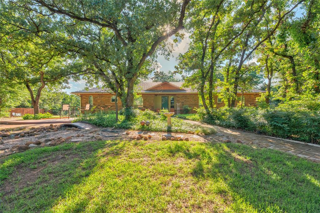 Location, a little land right outside of town, and a well cared for home, with a brand new kitchen. What more could you want?! Welcome to this captivating property,  why don't  you stay for a while and let me tell you about it? There is a private winding driveway, through which you will find a beautifully landscaped front yard. Complete with a wet weather cobblestone creek, as well as an arched wooden bridge, and mature trees thoughout the property. The rocks were sourced from a landowner in medicine park, and meticulously placed to create a hidden oasis, right outside of your front door. There is a trex deck as well, to sit and enjoy all that is to be beheld. 
The backyard is fully fenced in, and does have a big pole barn. There are three bedrooms in the home, as well as two full bathrooms, both of which were remodeled during ownership. The kitchen was fully remodeled in 2025, and boasts clean and modern esthetic. There is so much to appreciate, and see with this one, I truly don't see it lasting long! Schedule your private showing today, and this home could be yours tomorrow!