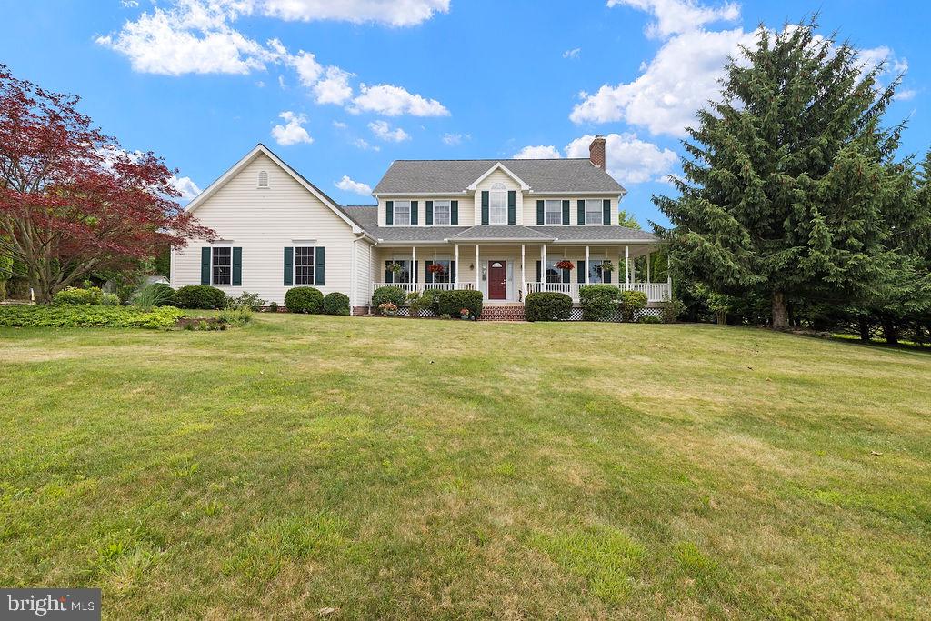 Exceptional 3,352 sq. ft. Colonial nestled in a private 10+ acre secluded setting and designed for both comfortable living and outdoor enjoyment. This thoughtfully maintained home features two spacious primary suites, including options on both the first and second floors, 3.5 baths, beautiful hardwood flooring, and solid-core wood doors throughout. The picturesque all-seasons room provides stunning views year-round and fills the home with natural light.The oversized garage offers an epoxied floor and a heated workshop space, perfect for hobbyists, car enthusiasts, or additional storage needs. Outdoors, you'll discover an extraordinary retreat featuring expansive living and entertaining areas, a covered front porch, gazebo, tranquil goldfish pond, firepit area, leisure pool, and a large fenced garden with raised beds. Golf enthusiasts will appreciate the private driving and chipping range right on the property.Offering a rare combination of quality craftsmanship, versatile living spaces, and resort-style amenities, this one-of-a-kind property delivers the perfect balance of privacy, recreation, and everyday luxury.