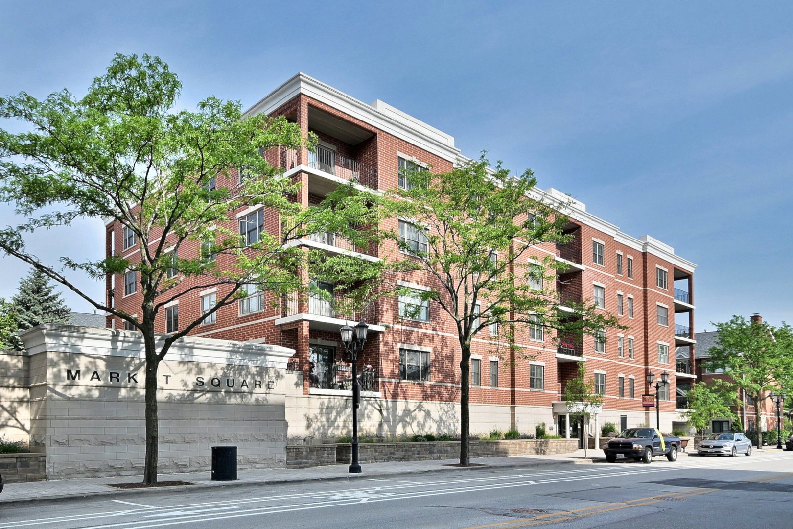 WONDERFUL SUNNY CONDO IN THE HEART OF DOWNTOWN ELMHURST WITH RARE 2 DEEDED PARKING SPACES INCLUDED! DESIRABLE NORTHEAST CORNER UNIT IN MARKET SQUARE, 1260 SQ FT "CITY SCAPE A" MODEL. THIS LIGHT-FILLED 2 BEDROOM, 2 BATHROOM UNIT WITH SPLIT BEDROOM FLOOR PLAN HAS A BRIGHT EASTERN EXPOSURE WITH NEW SLIDERS LEADING TO PRIVATE BALCONY. HEATED GARAGE WITH 2 SPOTS (G10 & G27) LOCATED ACROSS FROM ONE ANOTHER, ON CONVENIENT STREET LEVEL. EXTRA WIDE STORAGE UNIT IN GARAGE, ONE OF LARGEST IN THE BUILDING. STUNNING FLOORING IS TIMELESS. BEAUTIFUL KITCHEN WITH GRANITE COUNTERTOPS, WARM-TONED MAPLE CABINETRY, NEWER APPLIANCES, AND ELEGANT MARBLE TILE BACKSPLASH. NEW WINDOWS AND CUSTOM PLANTATION SHUTTERS. LARGE 12X5 BALCONY HAS EASTERN EXPOSURE GIVING EXCELLENT MORNING SUN. PRIMARY BEDROOM FEATURES WALK-IN CLOSET & PRIVATE BATH W/LARGE VANITY/DUAL SINKS & NEW STEP-IN SHOWER. NEWER WASHER/DRYER. UNIQUE DRYWALLED CEILINGS (IN LIEU OF POPCORN CEILING). NEWER BEAUTIFUL LIGHTING FIXTURES. THIS A MOVE IN READY CONDO WALKING DISTANCE TO DOWNTOWN ELMHURST AND METRA TRAIN STATION. HOA INCLUDES HEAT, GAS, TRASH & WATER, & SECURED ENTRY. HEATED FLOORS KEEP YOUR TOES TOASTY IN WINTER! ENJOY MAINTENANCE FREE LIVING WHILE ENJOYING THE SHORT WALK TO ALL ELMHURST HAS TO OFFER, INCLUDING RESTAURANTS, HEALTH CLUB, WILDER PARK AND MANSION, ELMHURST PUBLIC LIBRARY, SHOPPING AND METRA TRAIN STATION. QUICK CLOSE POSSIBLE.