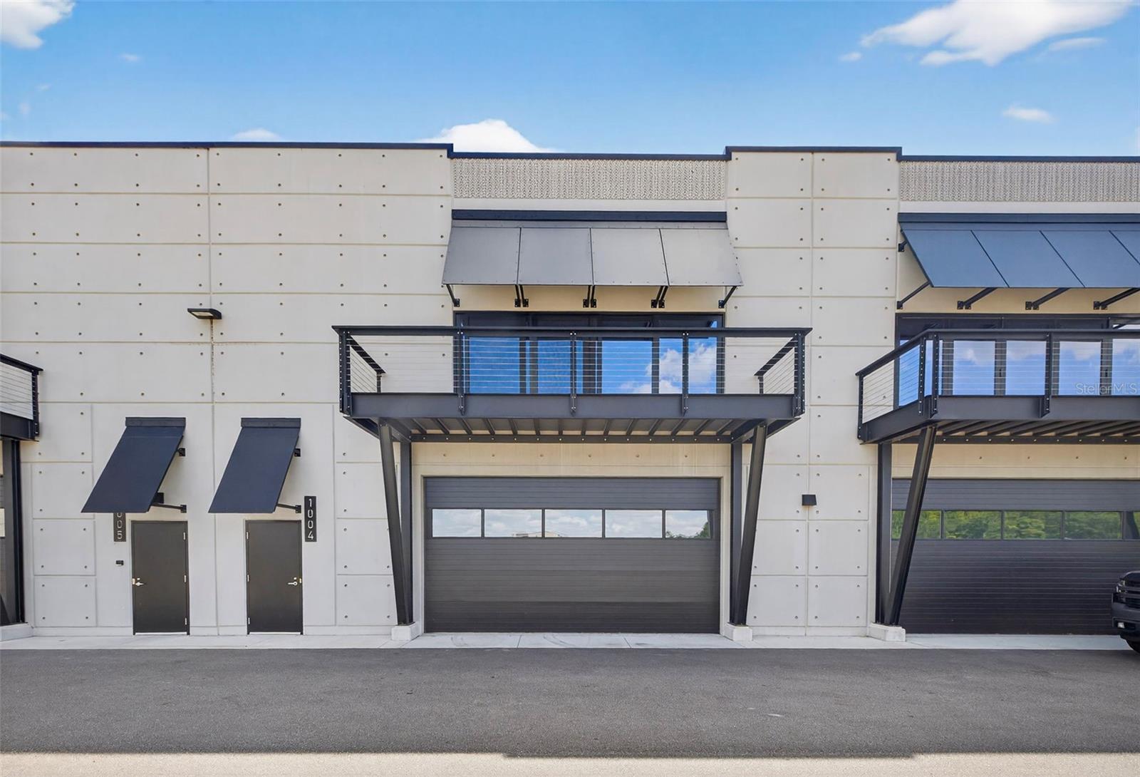 Rare opportunity to own one of the most exclusive balcony units at The Motor Enclave—only 6 of 300 offer views of nearly the entire 1.72-mile racetrack. This 1,435 SF private garage features soaring 25' ceilings and a private balcony overlooking the action, with room to add a mezzanine for additional space. Create your dream workshop, office, or luxury motorsport retreat. Located on 200 acres just minutes from downtown Tampa and adjacent to Tampa Executive Airport, The Motor Enclave is the world’s largest private motorsports community. The track was designed by Formula 1 architect Hermann Tilke. Owners enjoy a 100-acre Off-Road Experience, 2-acre Vehicle Dynamics Pad, resort-style pool with poolside bar, and a 37,000 SF Event Center. A one-of-a-kind lifestyle offering year-round social events, 24/7 access, and unmatched automotive amenities.